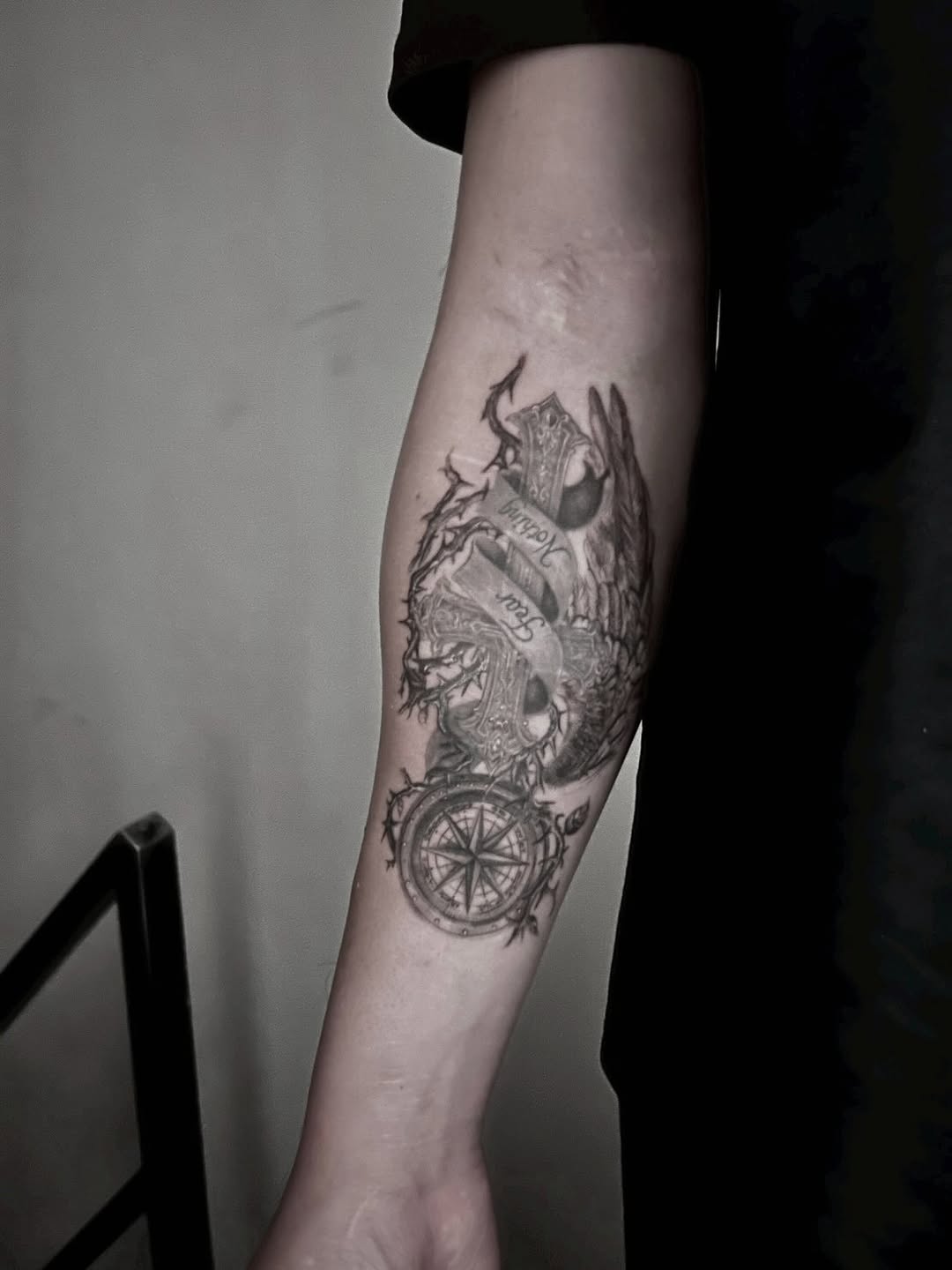 Cross with wings and compass realism tattoo on the forearm by 墨匠紋身|新店店, New Taipei City