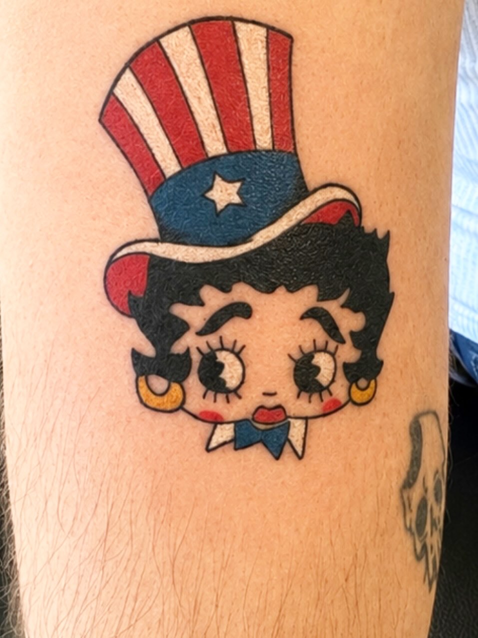 Betty Boop in Uncle Sam hat neo-traditional tattoo on the forearm by Stoney