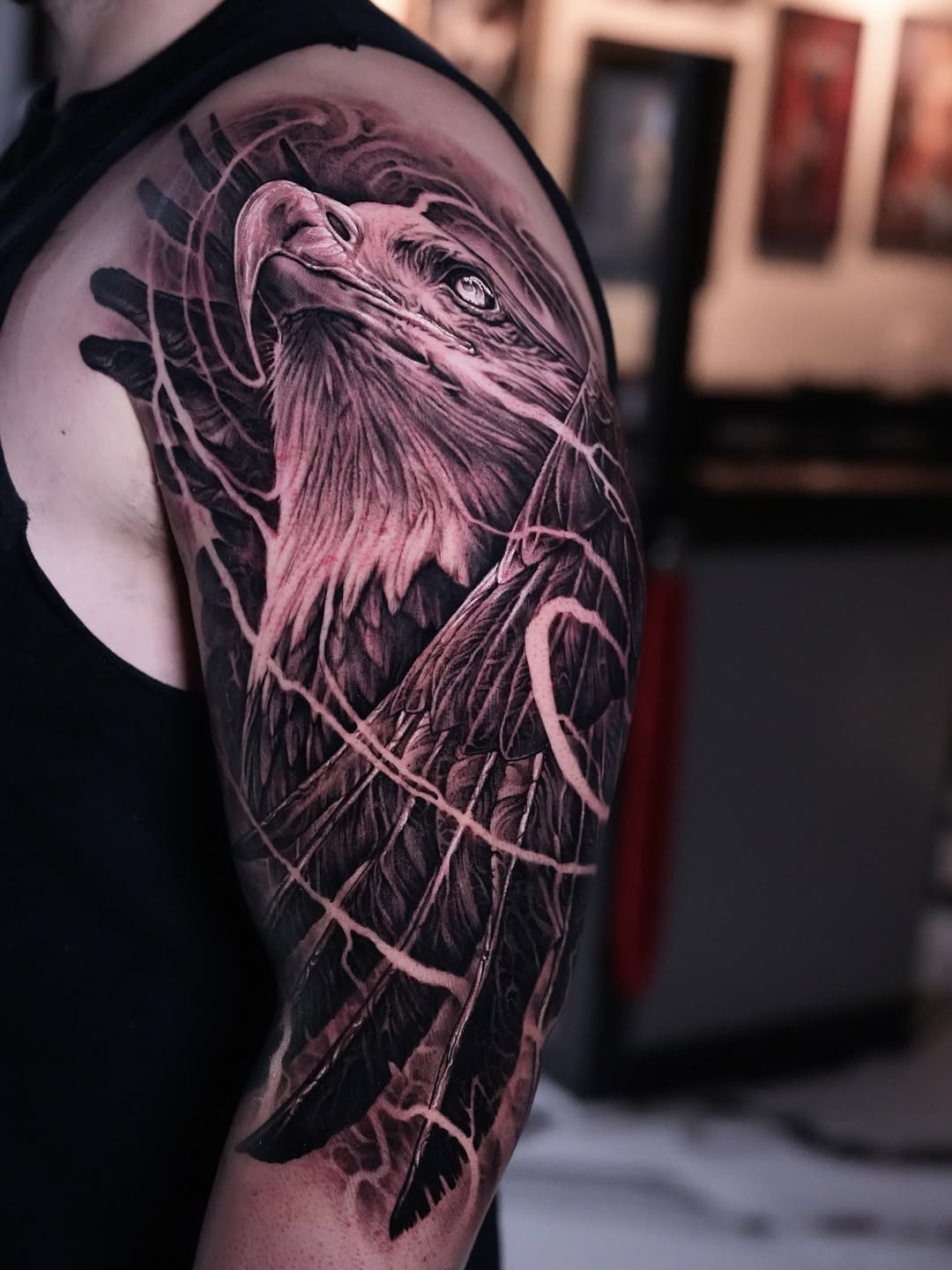 Eagle head and wings realism tattoo on the upper arm by Nico Perez