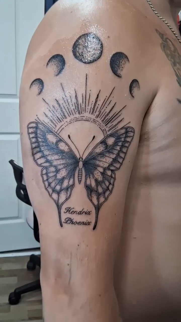 Butterfly with moon phases fine line tattoo on the shoulder by Tanya Tattoota