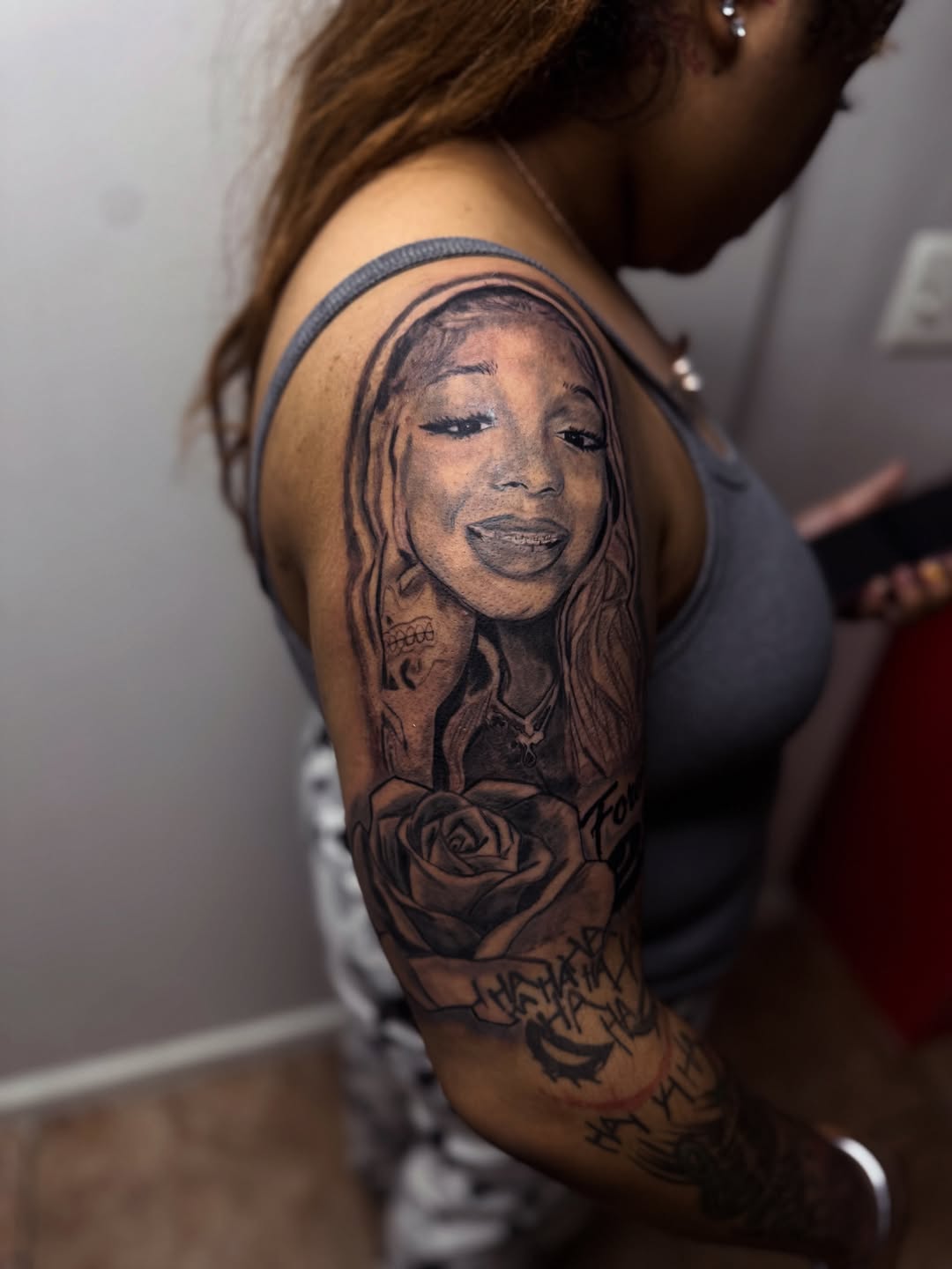 Portrait of a woman and rose Chicano tattoo on the upper arm by Uncle Fade Tattoo Artist ✍🏾
