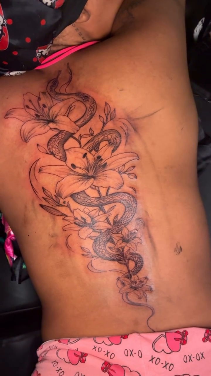 Dragon and lilies tattoo fine line tattoo on the back by Detroit tattoo Artist