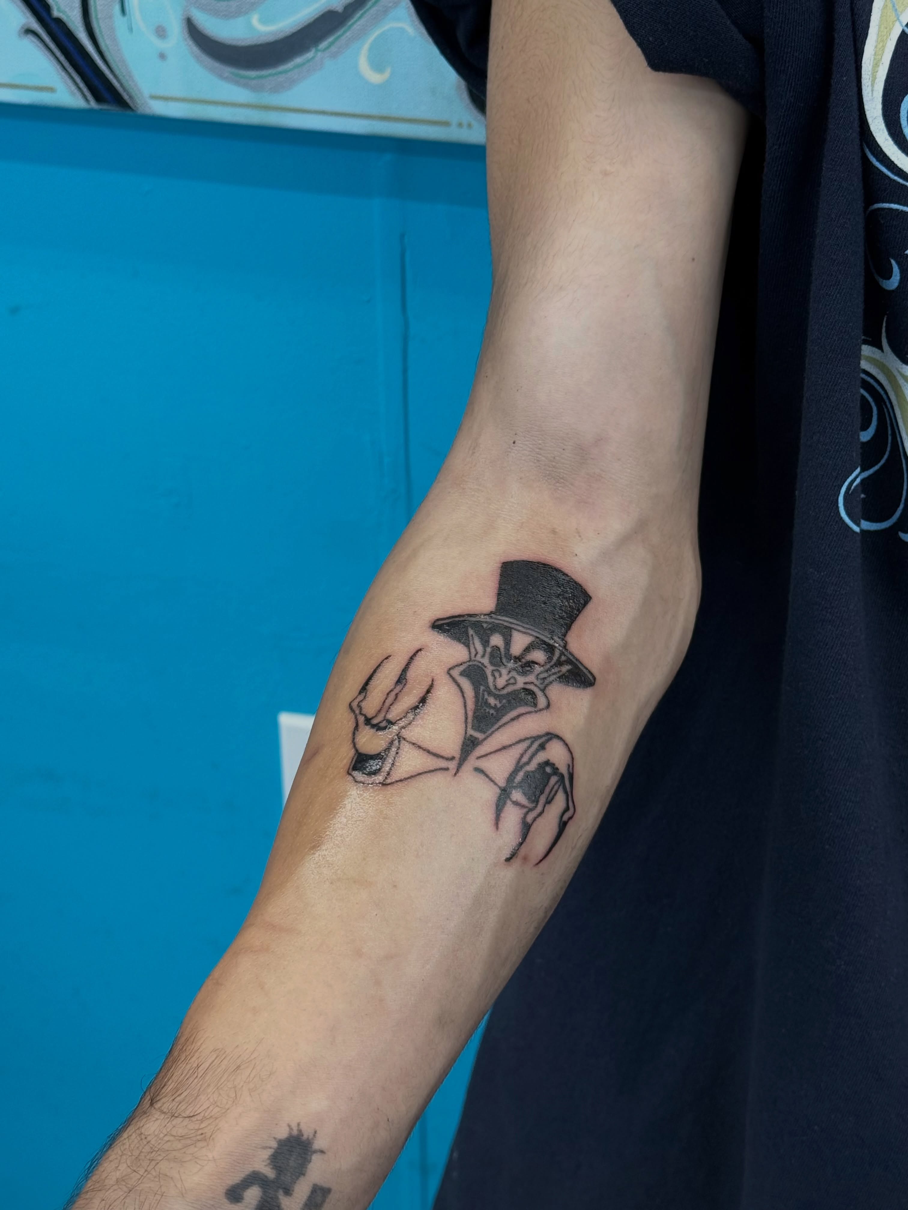 Joker black and grey tattoo on the forearm by ⠀Greave
