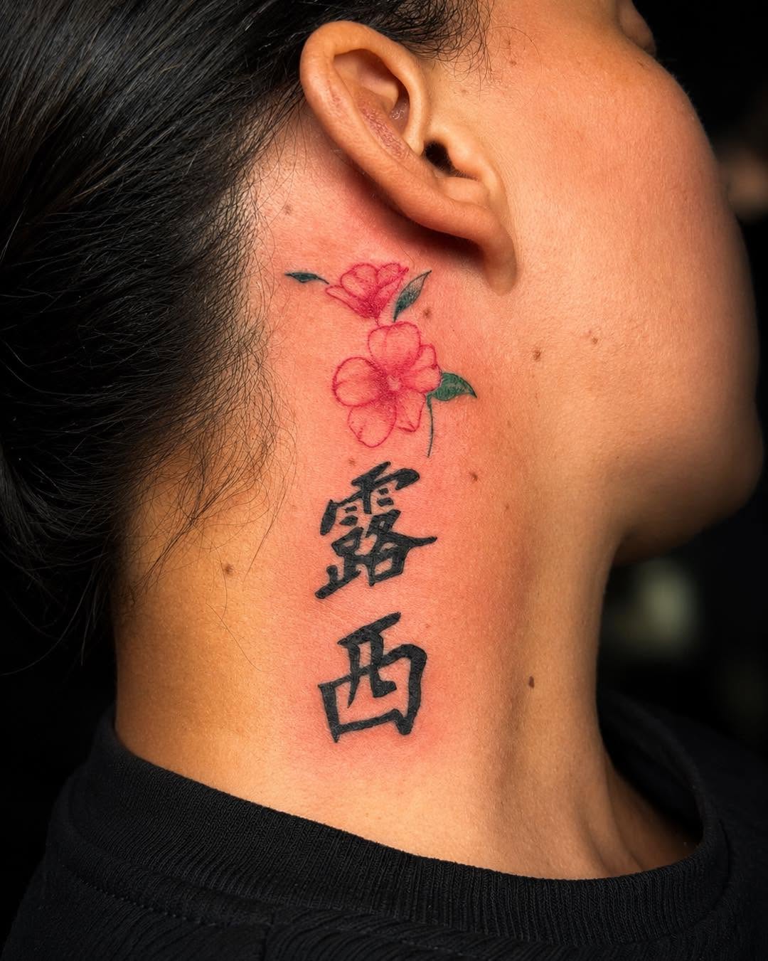 Japanese characters and flowers tattoo on the neck by Flamboyant