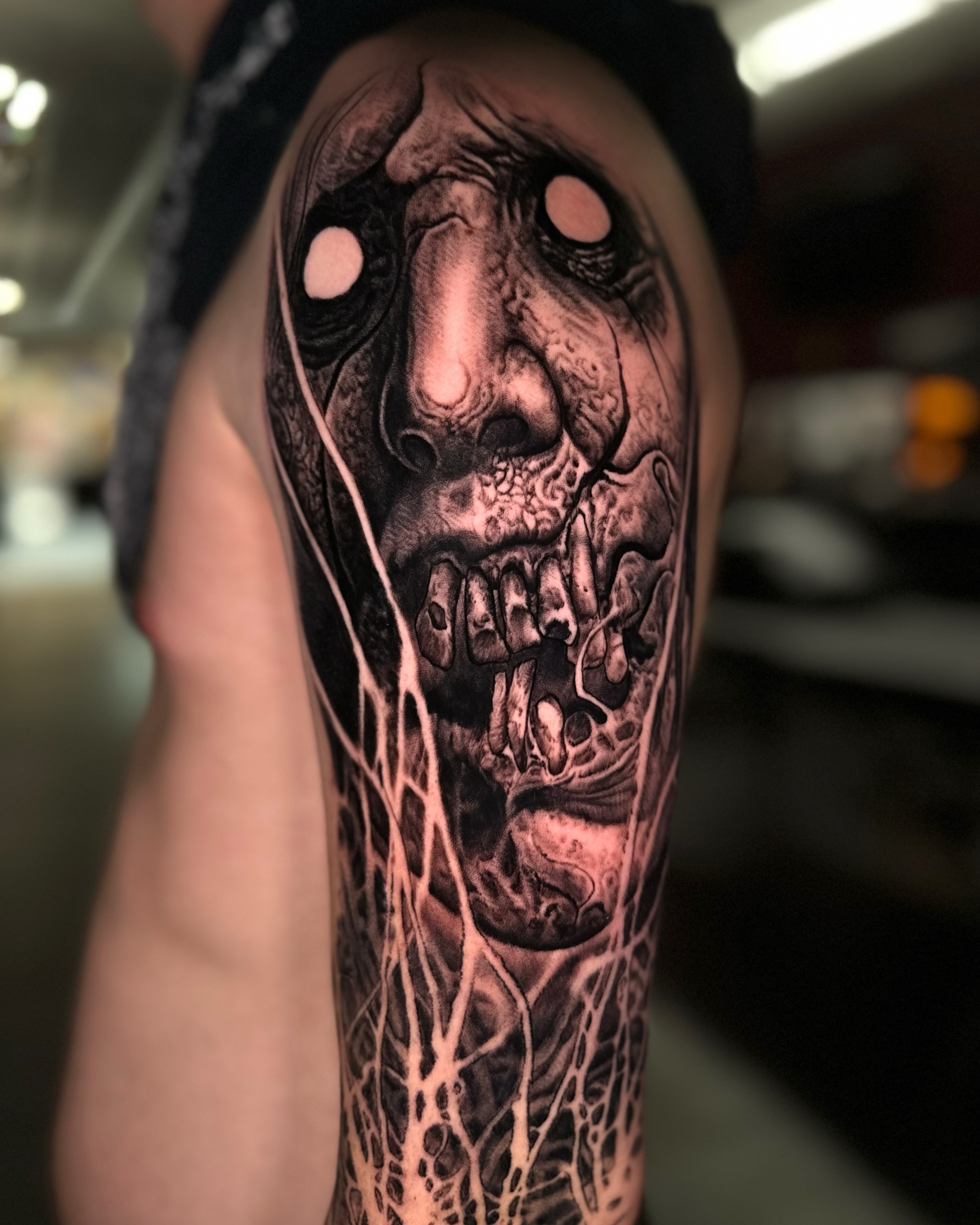 Zombie face with abstract elements surrealism tattoo on the forearm by Jesse White, Mentor, Ohio