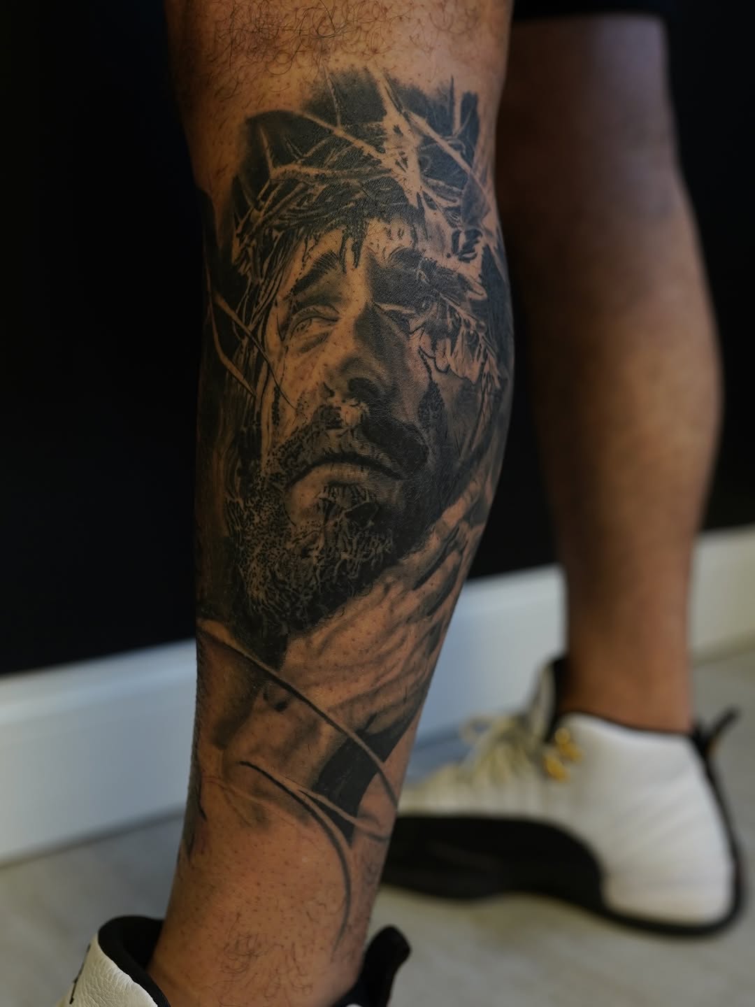 Jesus Christ portrait surrealism tattoo on the forearm by Eric RudeInk