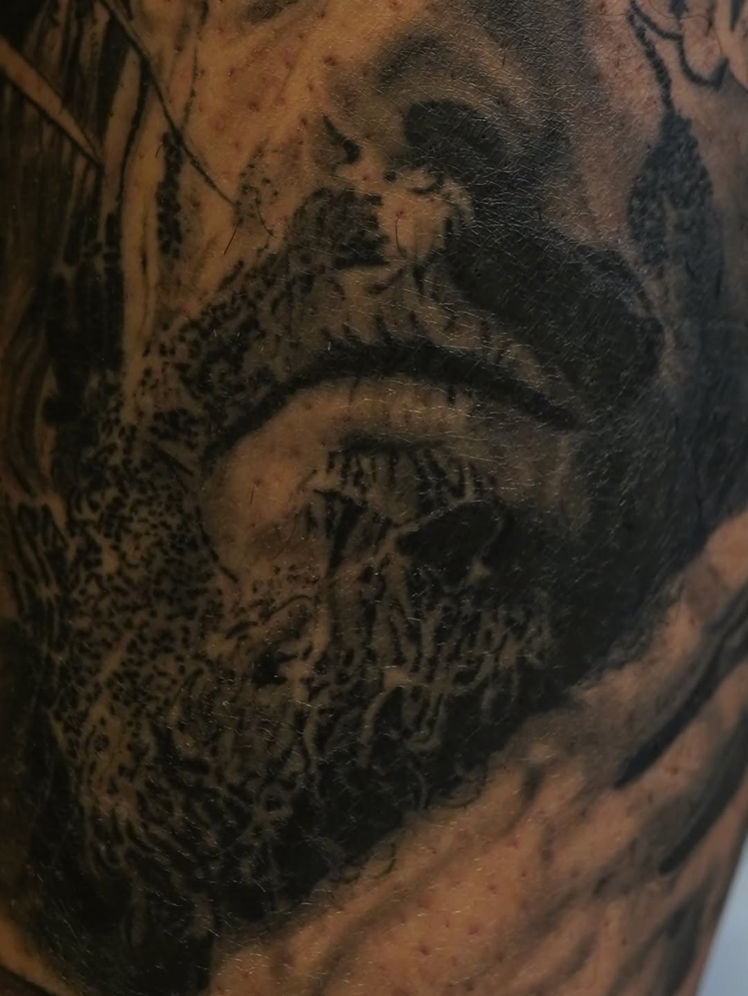 Portrait of a man surrealism tattoo on the forearm by Eric RudeInk