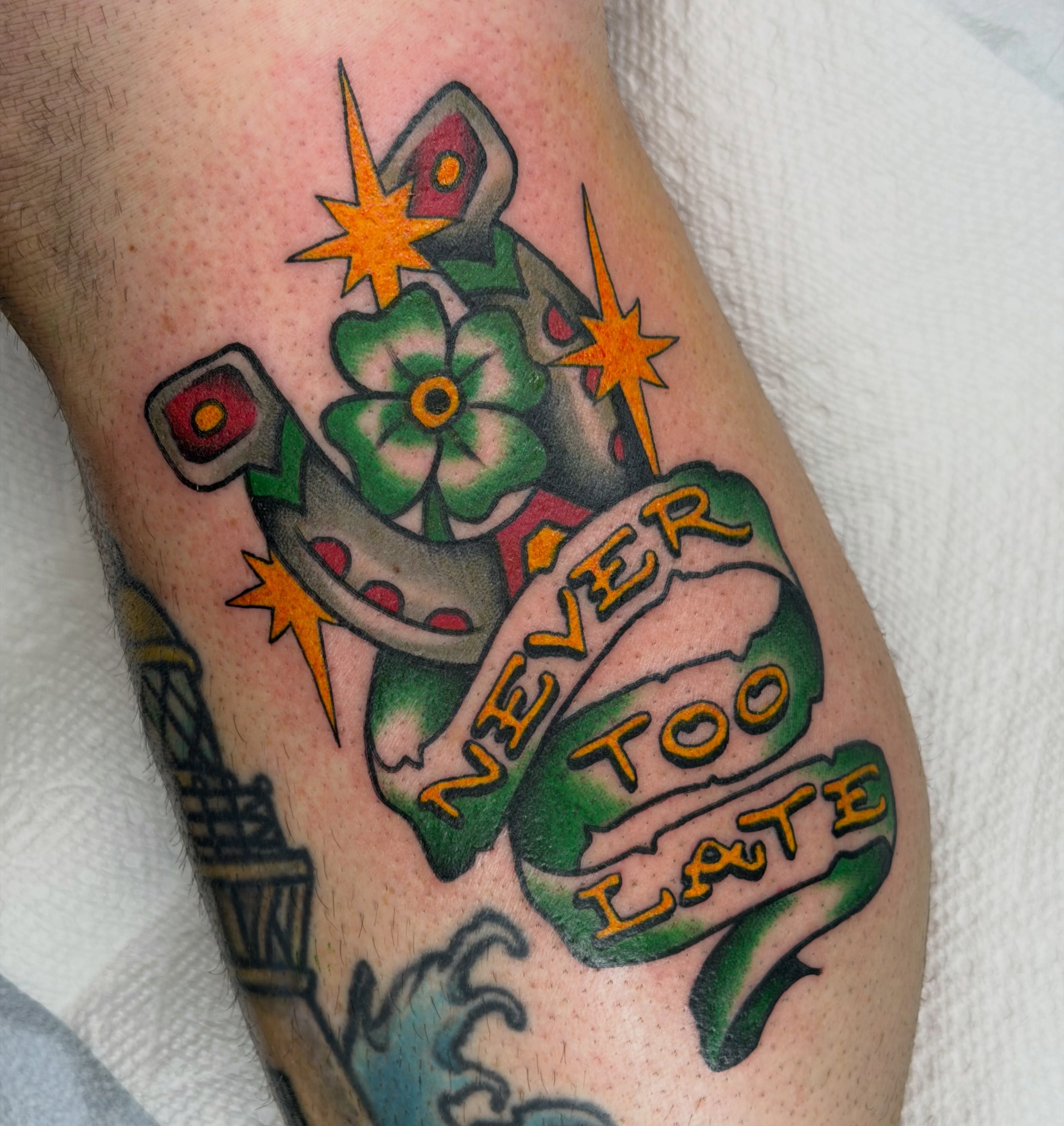 Horseshoe and flower American traditional tattoo on the forearm by Colbylee Tattoo Norwich
