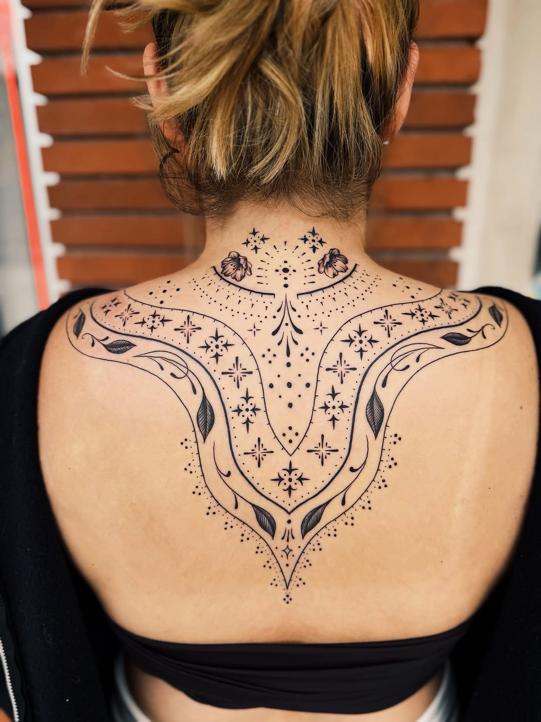 Ornamental back piece with floral elements ornamental tattoo on the back by @amandahowtattoo