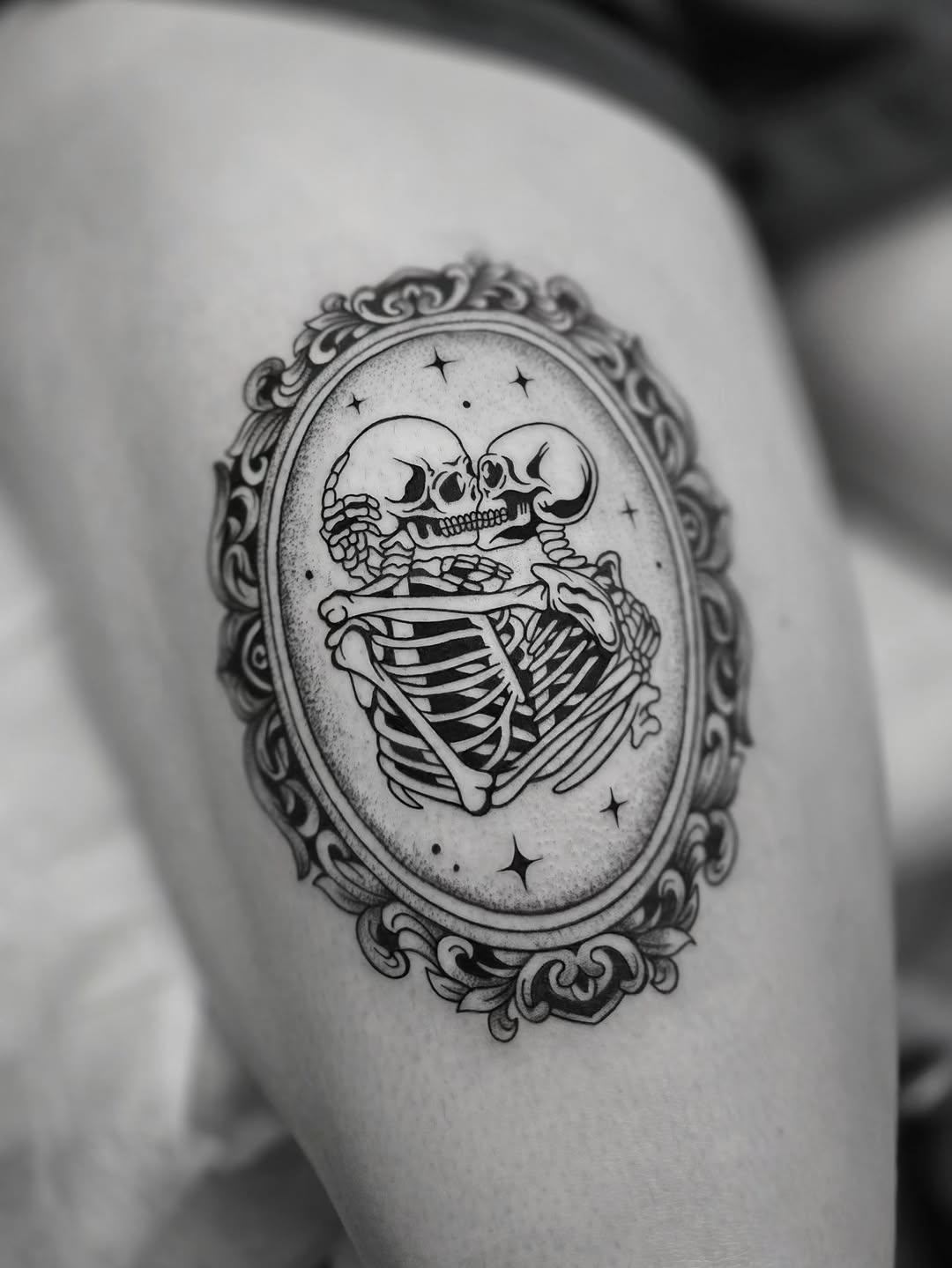 Skeletons in a frame dark art tattoo on the thigh by Kirstie Lew Tattoo
