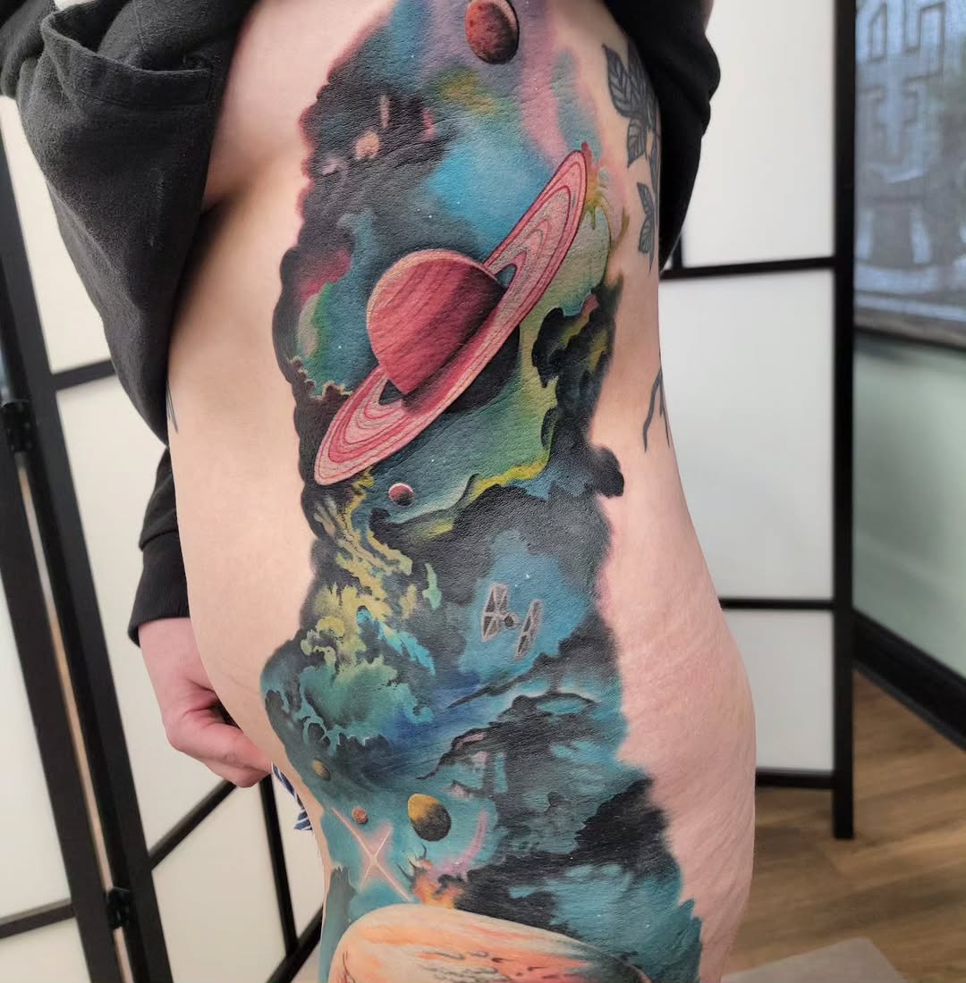 Space scene with planets and starships watercolor tattoo on the thigh by Chantel Chan, Portland, Oregon