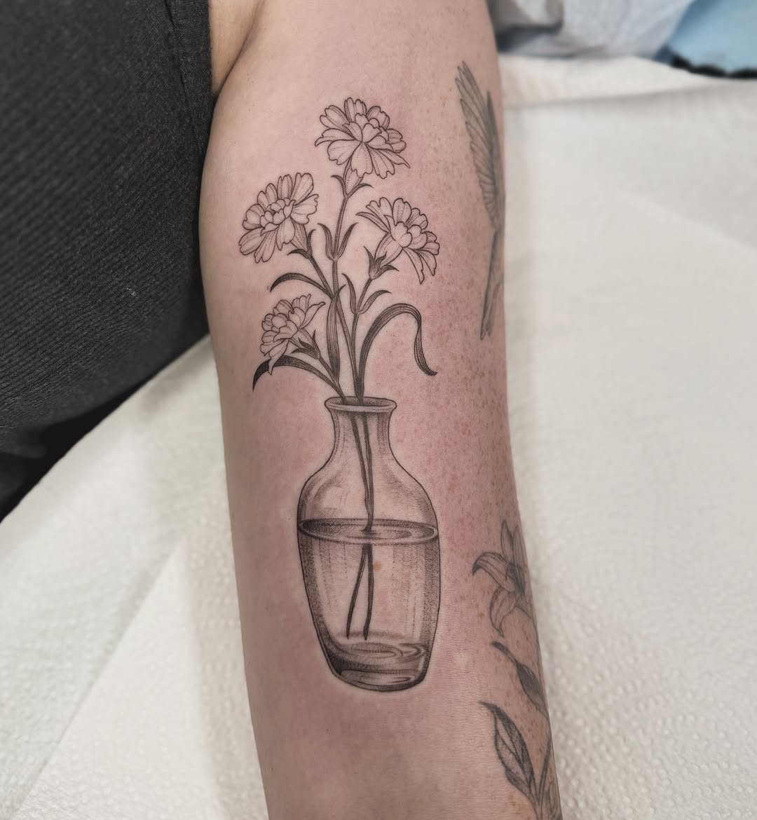 Flowers in vase black and grey tattoo on the forearm by Fineline tattoos by Kinsey