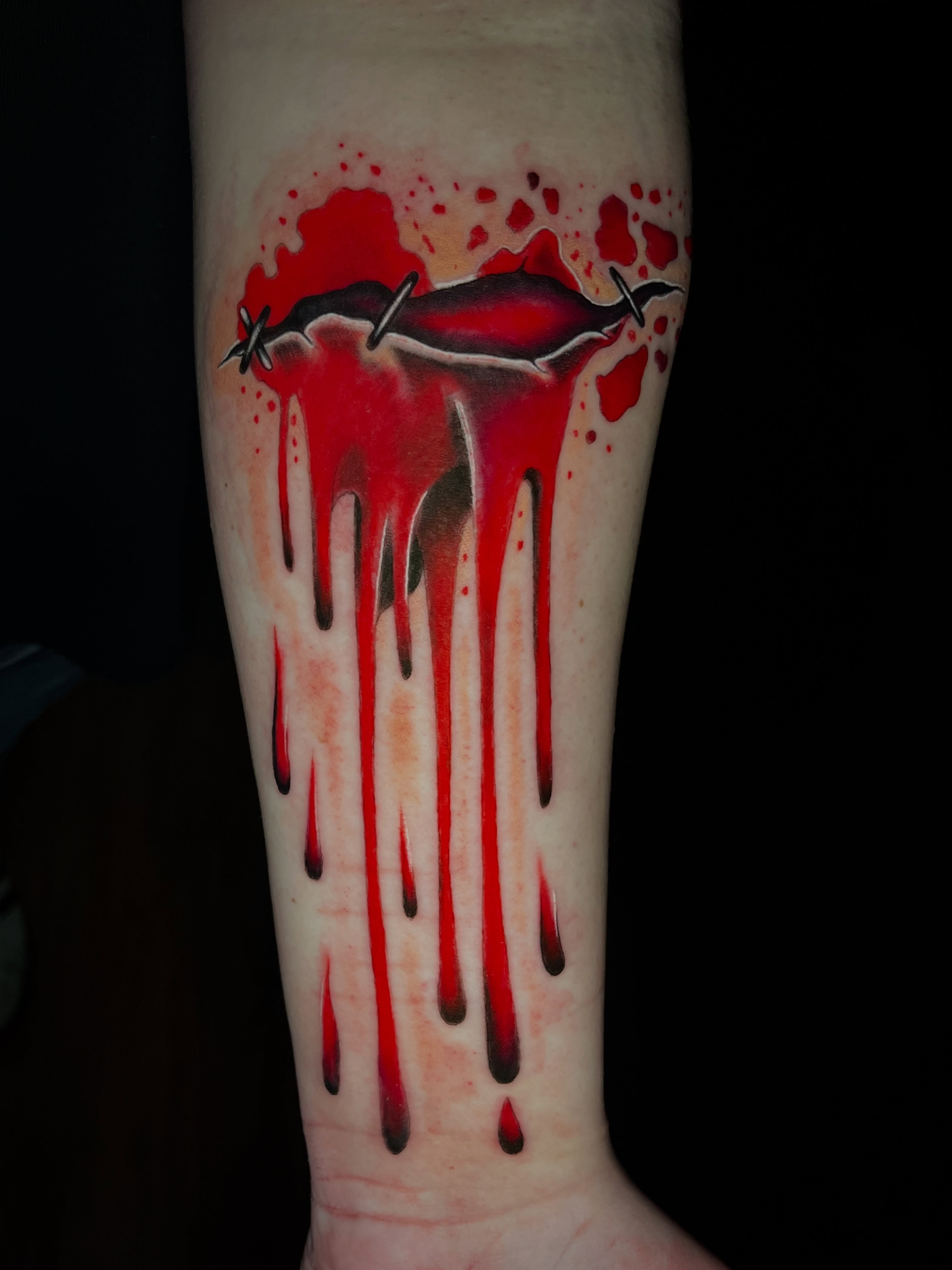 Bleeding lips realism tattoo on the forearm by Kyle Schneider
