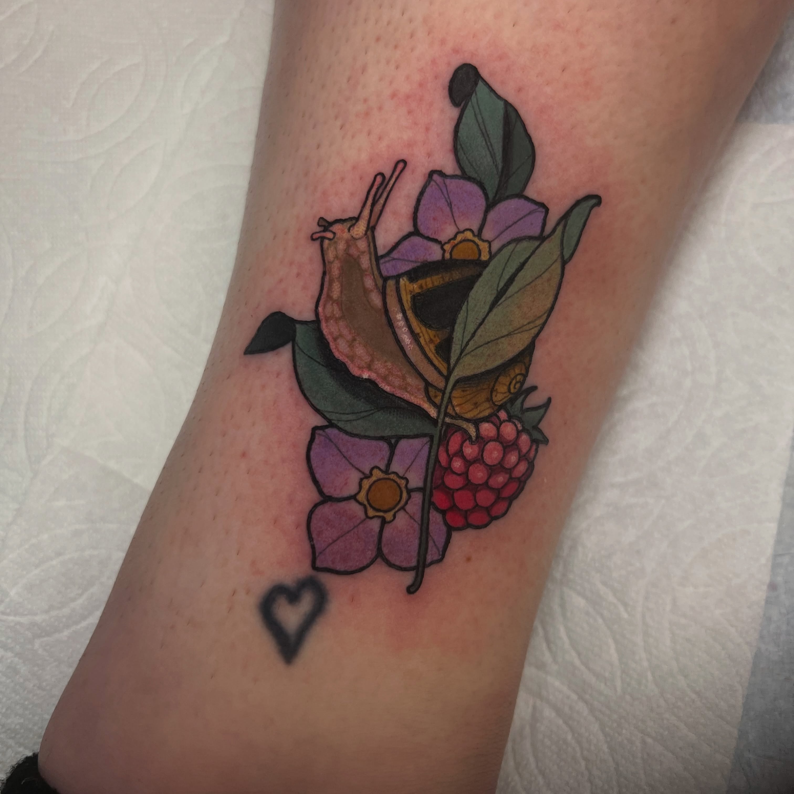 Snail and flowers new school tattoo on the forearm by Rennie Tattoo