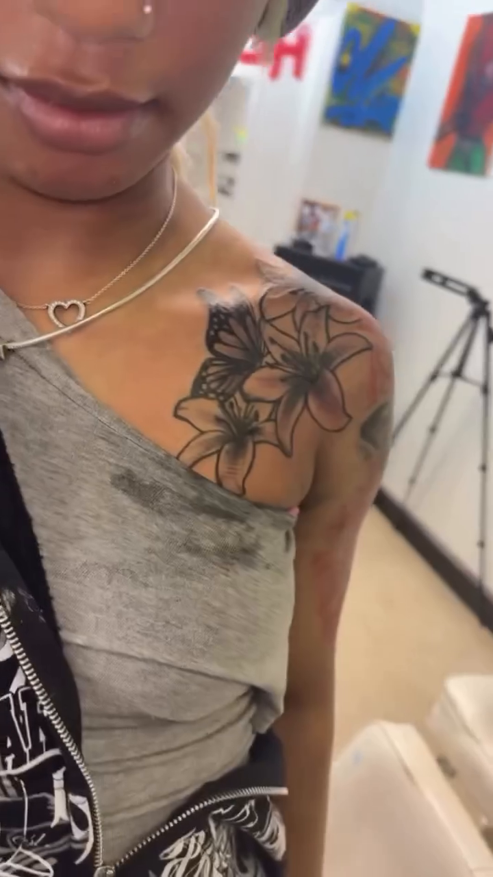 Lily and butterfly tattoo fine line tattoo on the shoulder by Exotic Motion🌪️