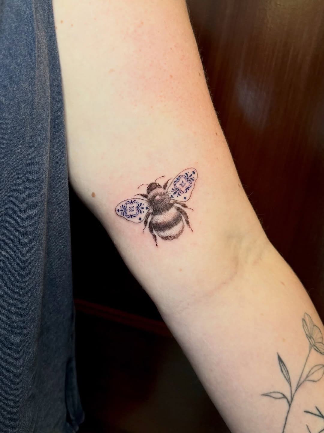 Bee with patterned wings fine line tattoo on the forearm by Ana Blatt