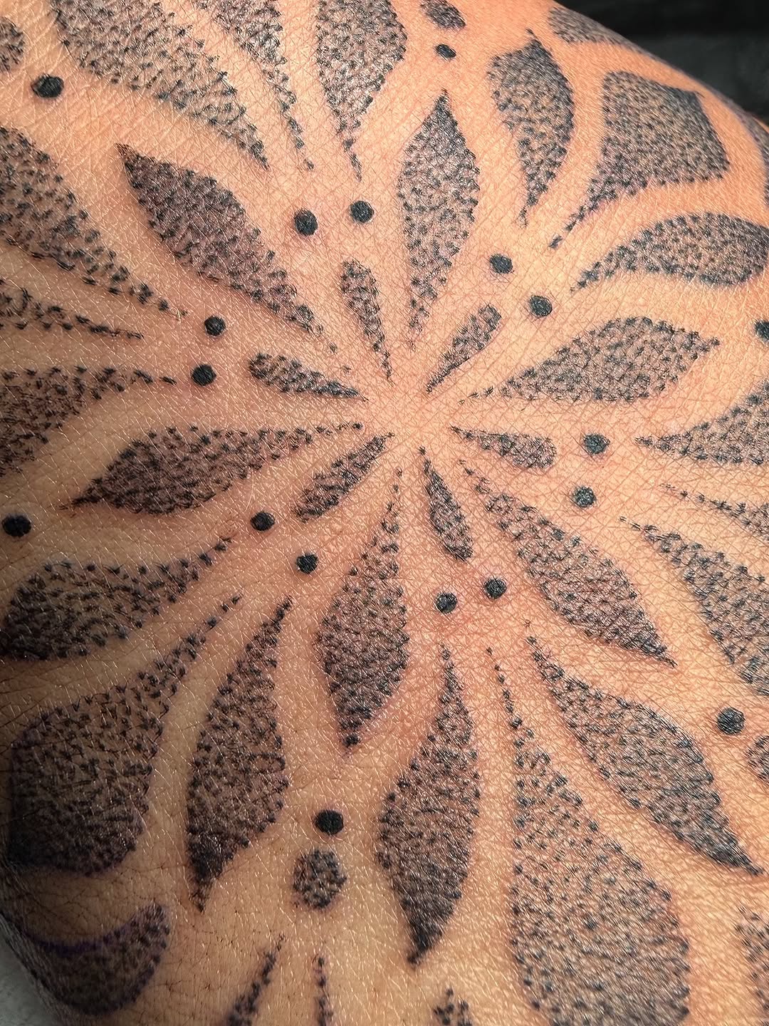 Geometric mandala dotwork tattoo on the forearm by Dee, San Diego, California