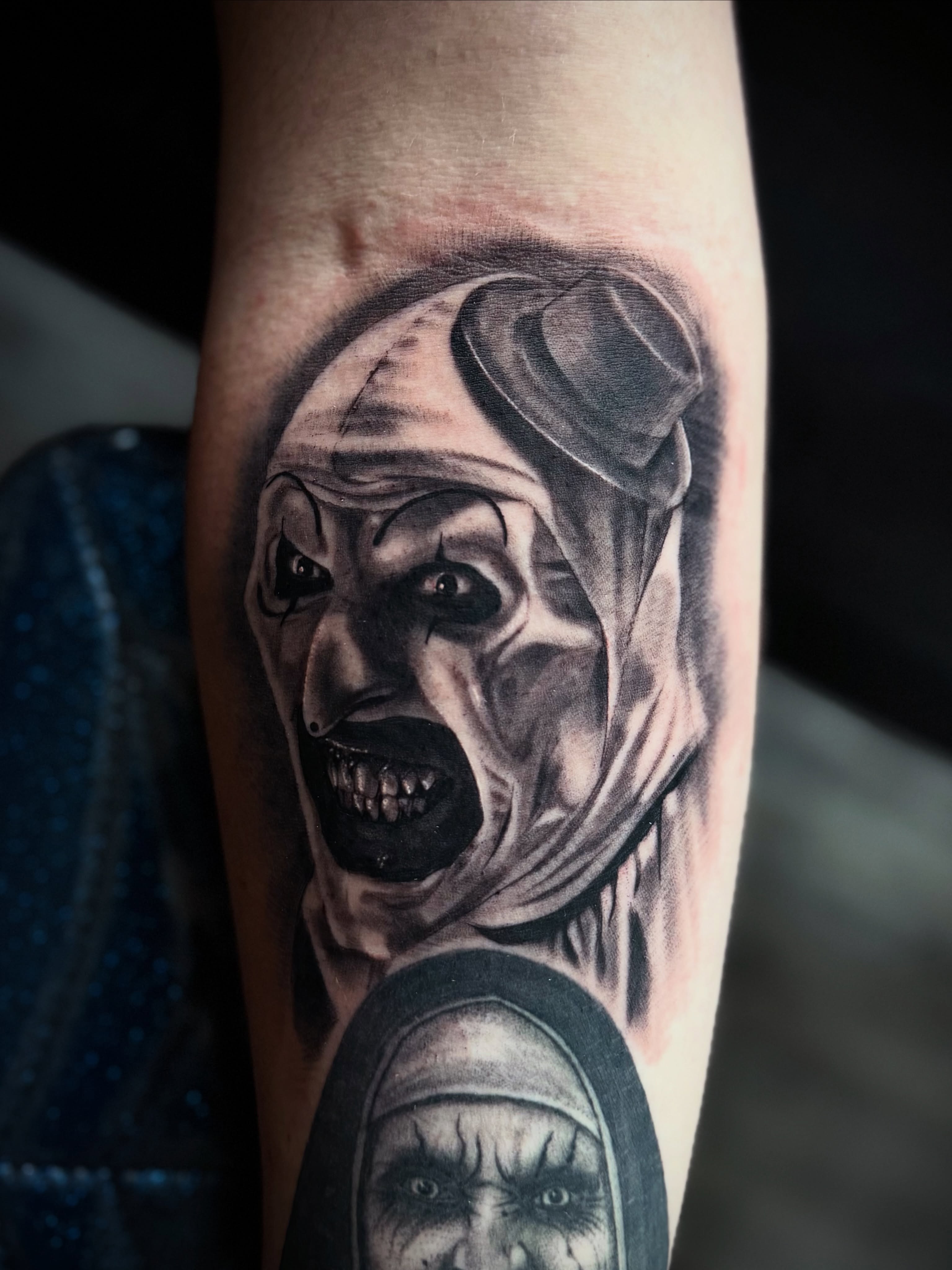 Clown and nun realism tattoo on the forearm by Luis Marrufo