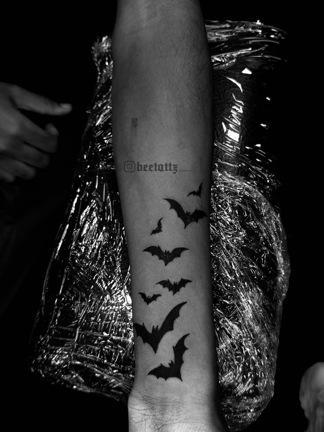 Flock of bats tattoo on the forearm by Brinkley McGill
