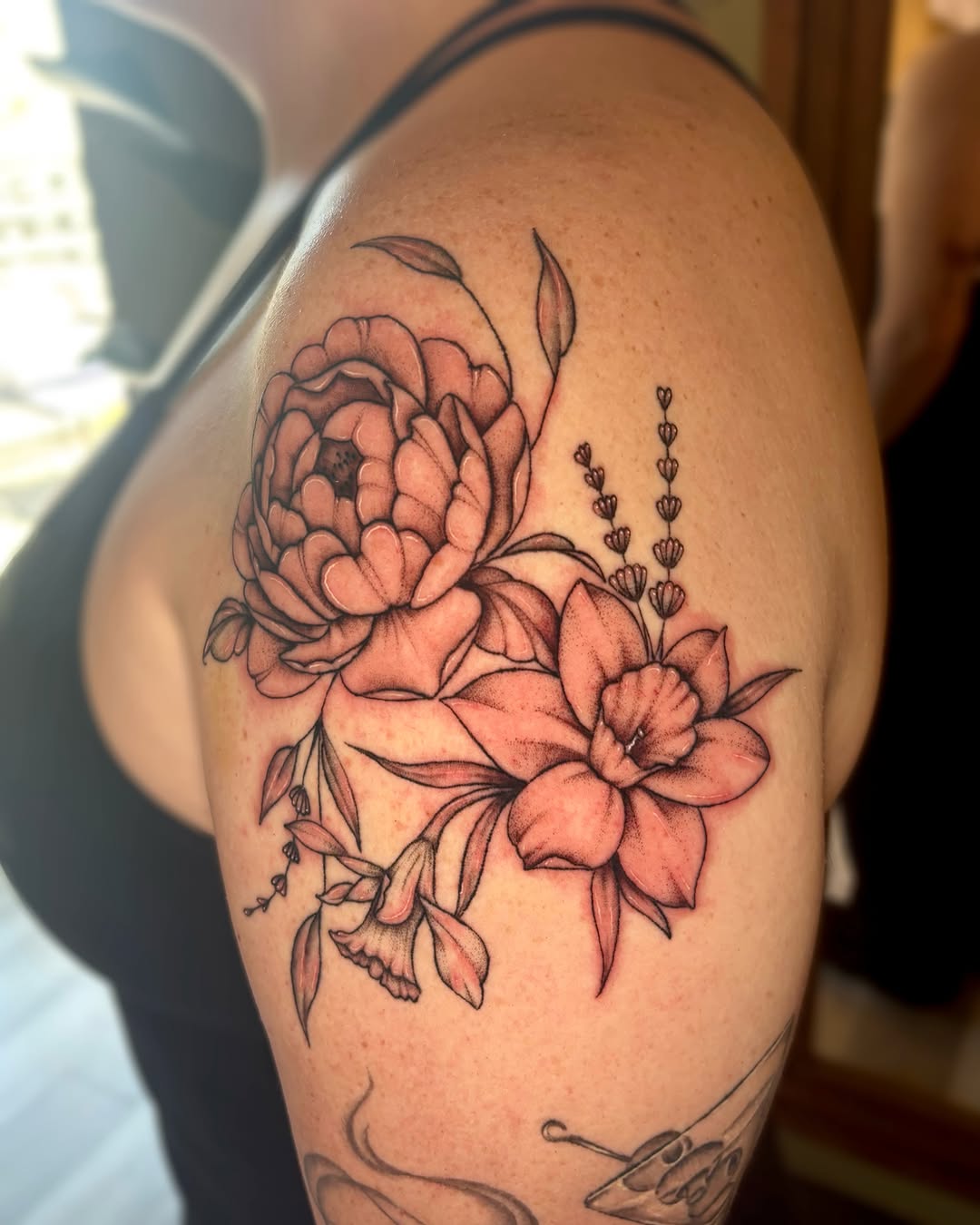 Peony and daffodils dotwork tattoo on the shoulder by Bianca Cattapan