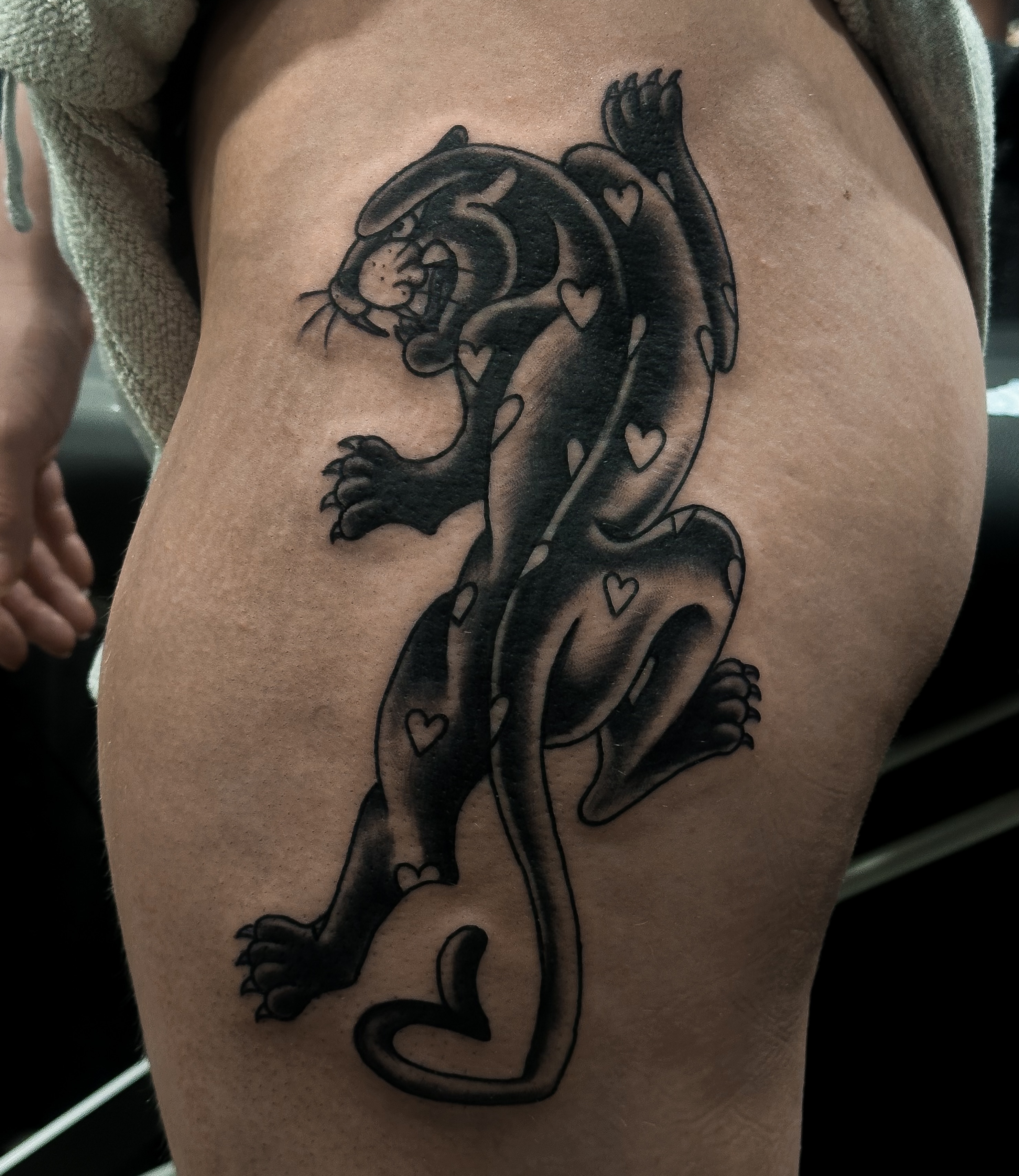 Panther black and grey tattoo on the thigh by Victoria
