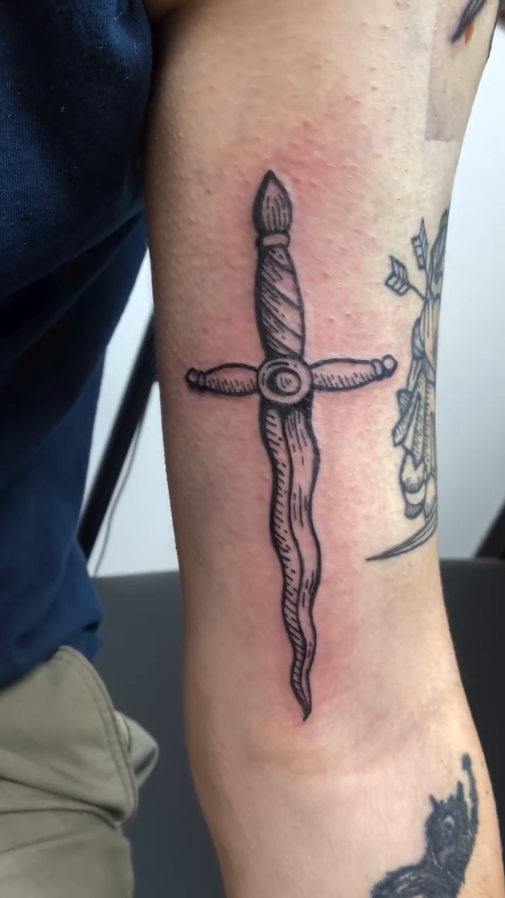 A dagger tattoo American traditional tattoo on the forearm by Laura🦋