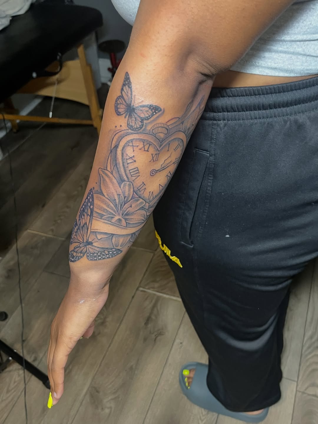 Pocket watch with butterflies and flowers tattoo on the forearm by SpicyMvstardInkk