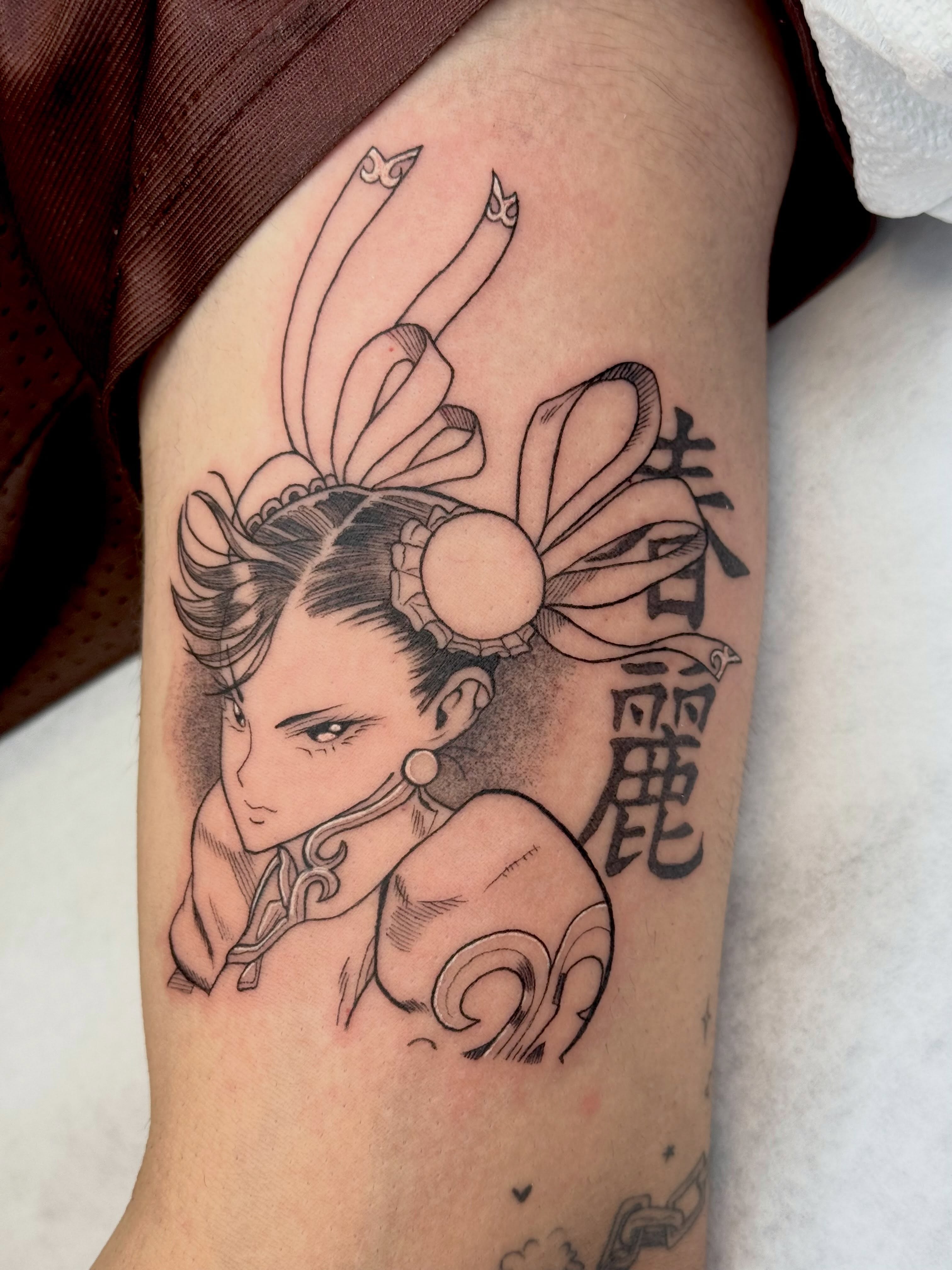 Anime character anime tattoo on the forearm by Em Krieg