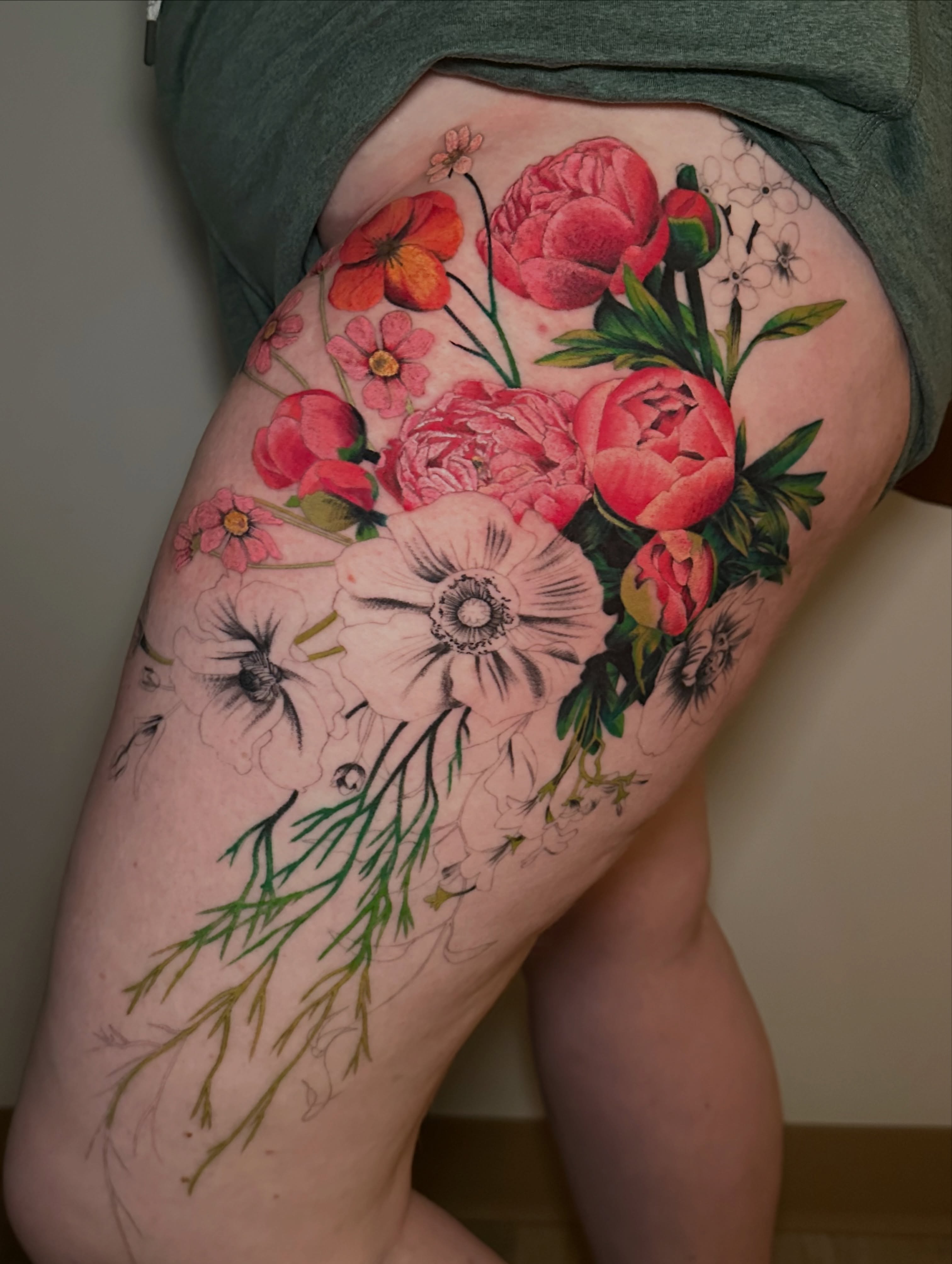 Floral bouquet realism tattoo on the thigh by Les