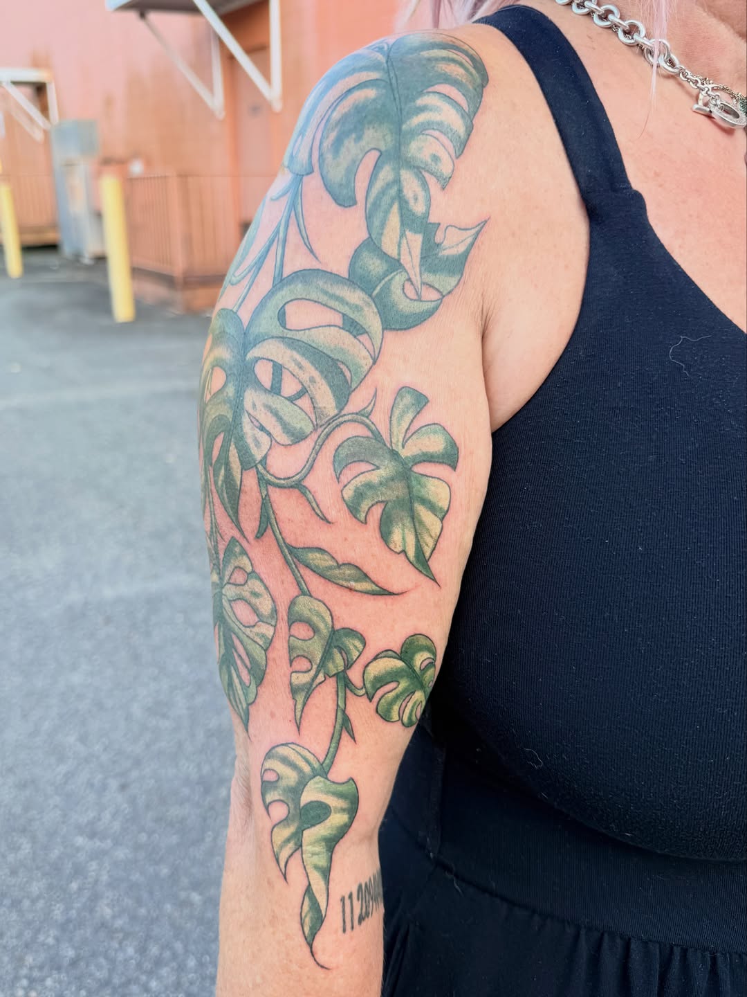 Monstera plant tattoo on the upper arm by Maggie George