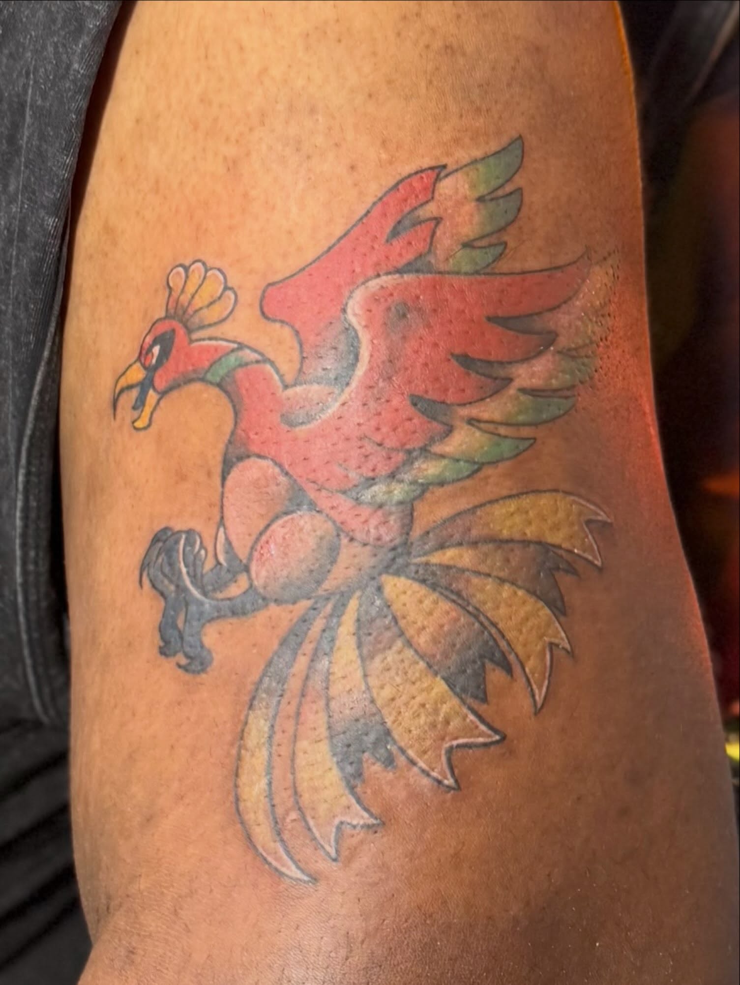 Phoenix American traditional tattoo on the forearm by Robin Wintringham