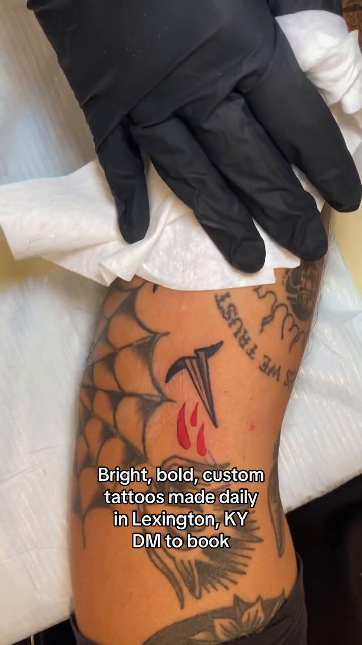 Eagle with banner and nails American traditional tattoo on the forearm by Ian Dorman
