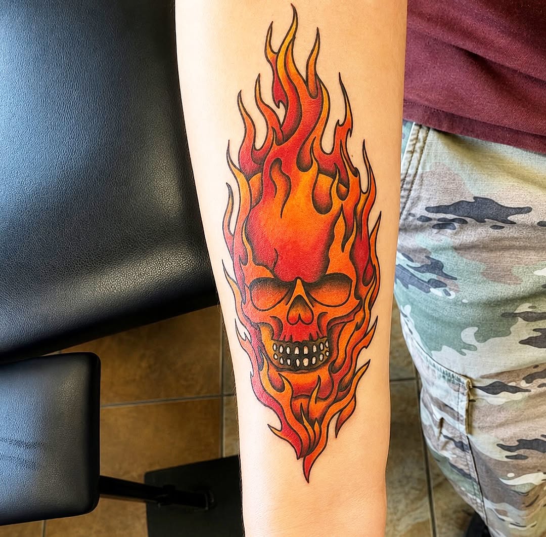 Skull on fire American traditional tattoo on the forearm by Stoney