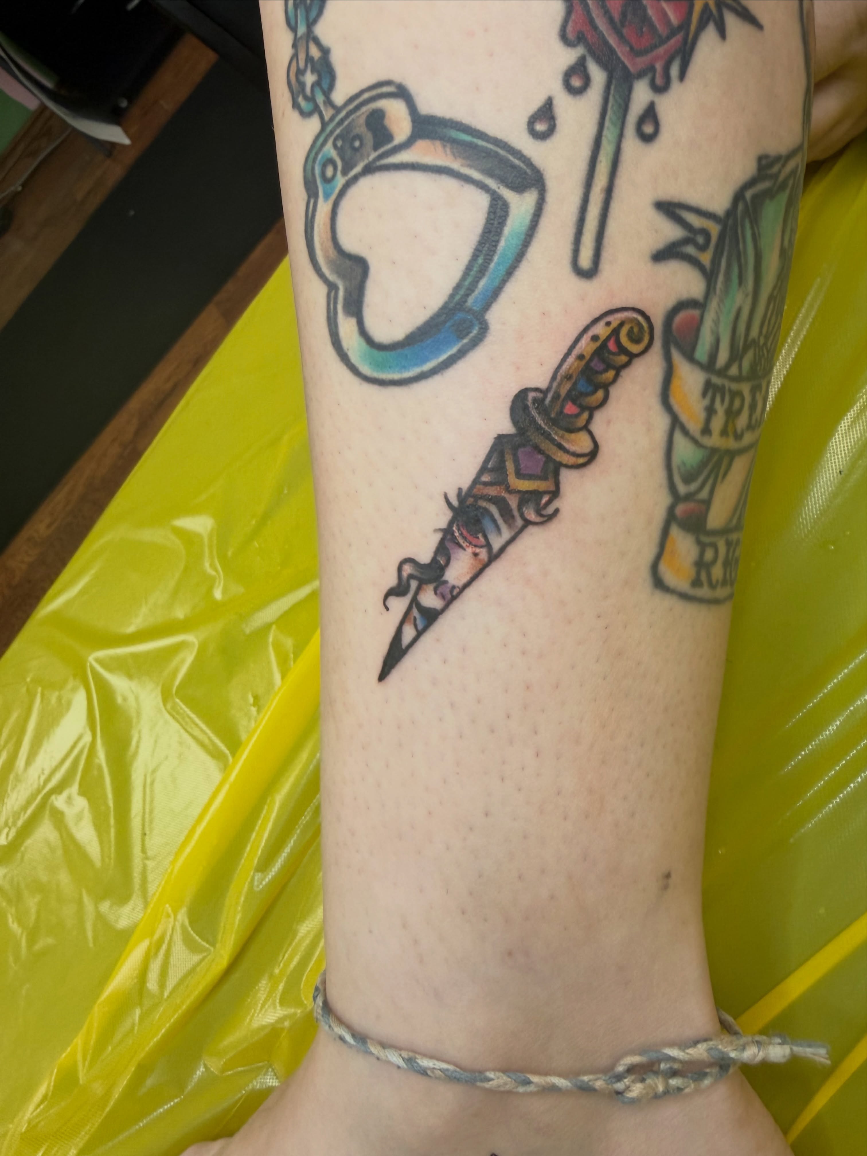 Knife and heart American traditional tattoo on the forearm by Luna Faye