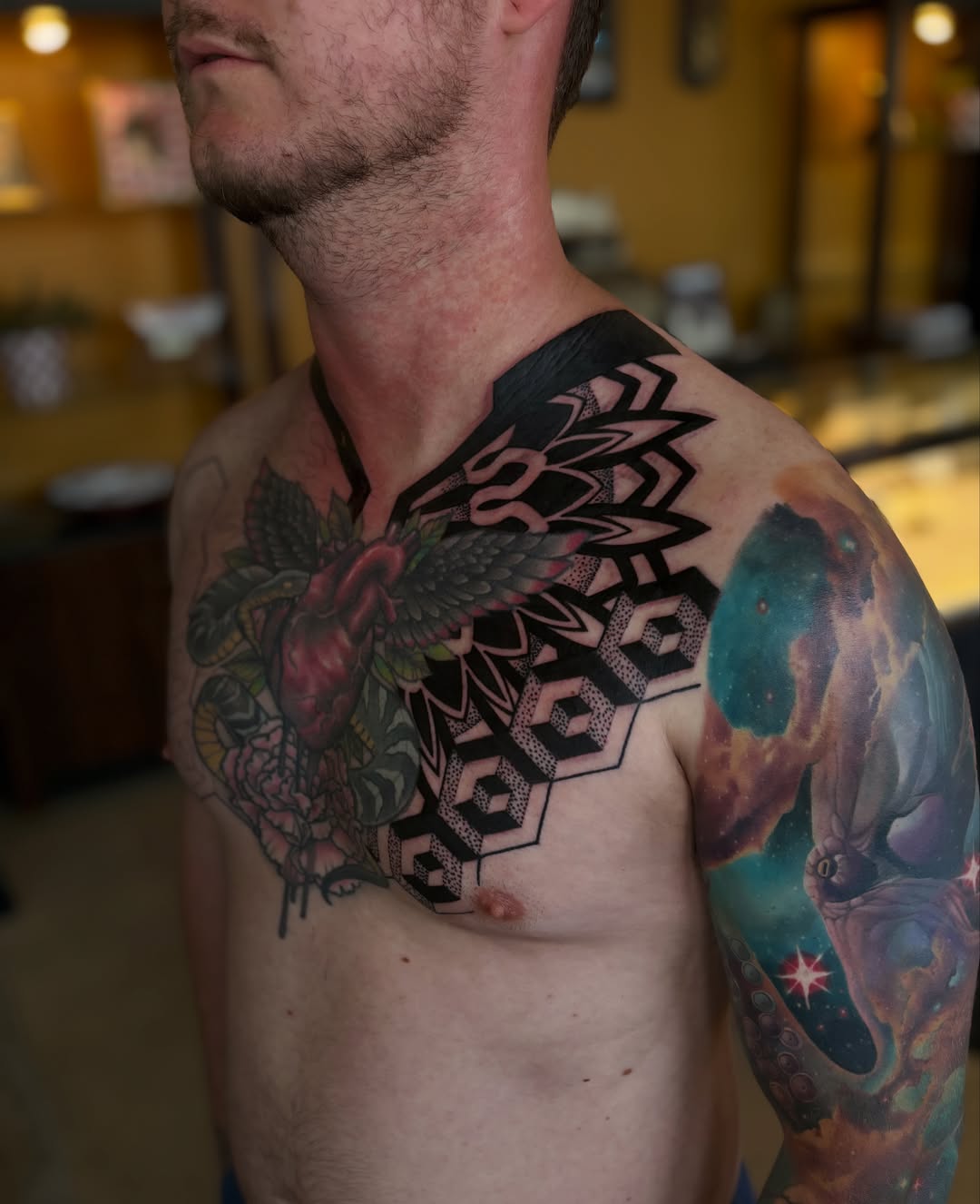 Heart and snake geometric tattoo on the chest by Tony Lucero, Wheat Ridge, Colorado