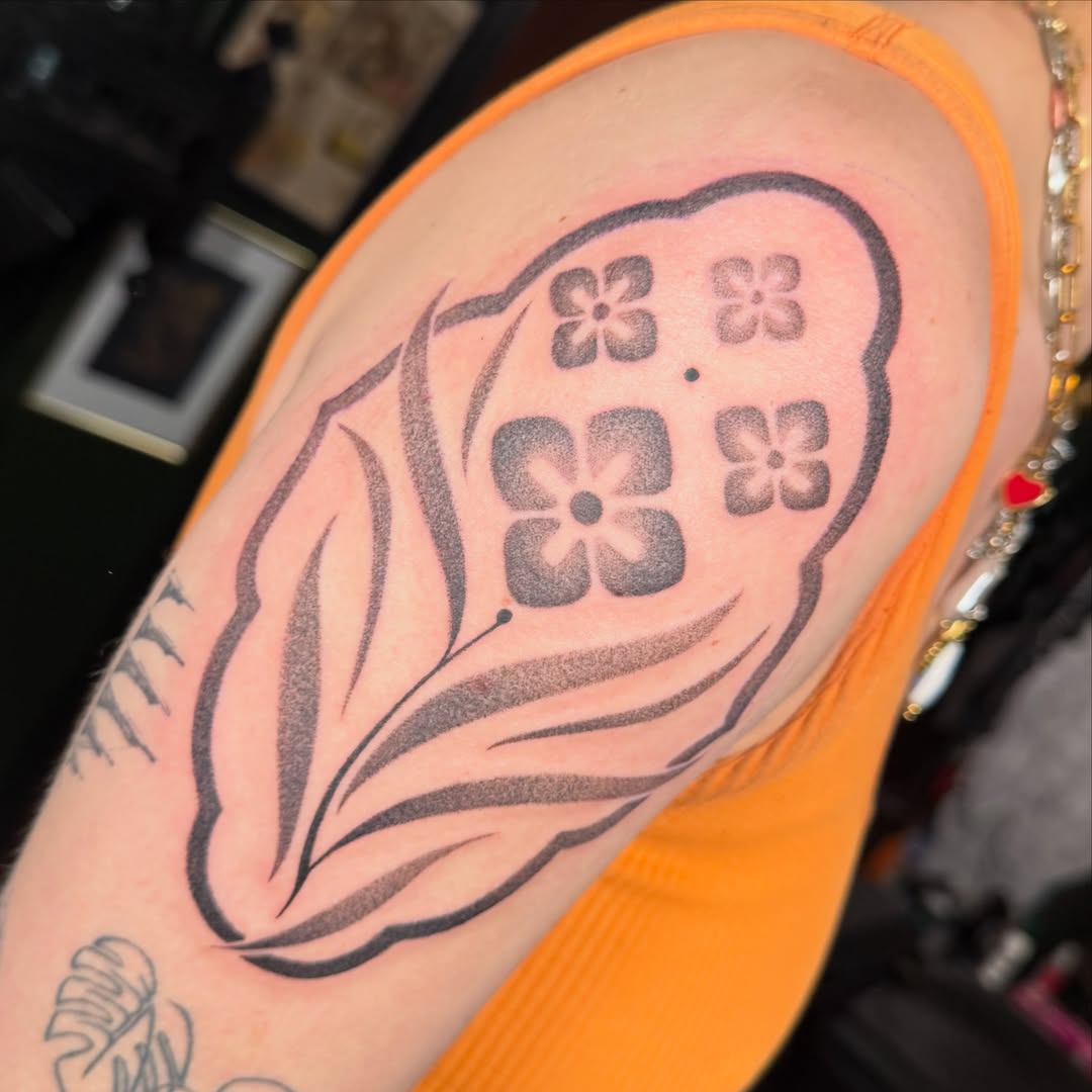 Flower black and grey tattoo on the upper arm by Em ✨PA Tattooer