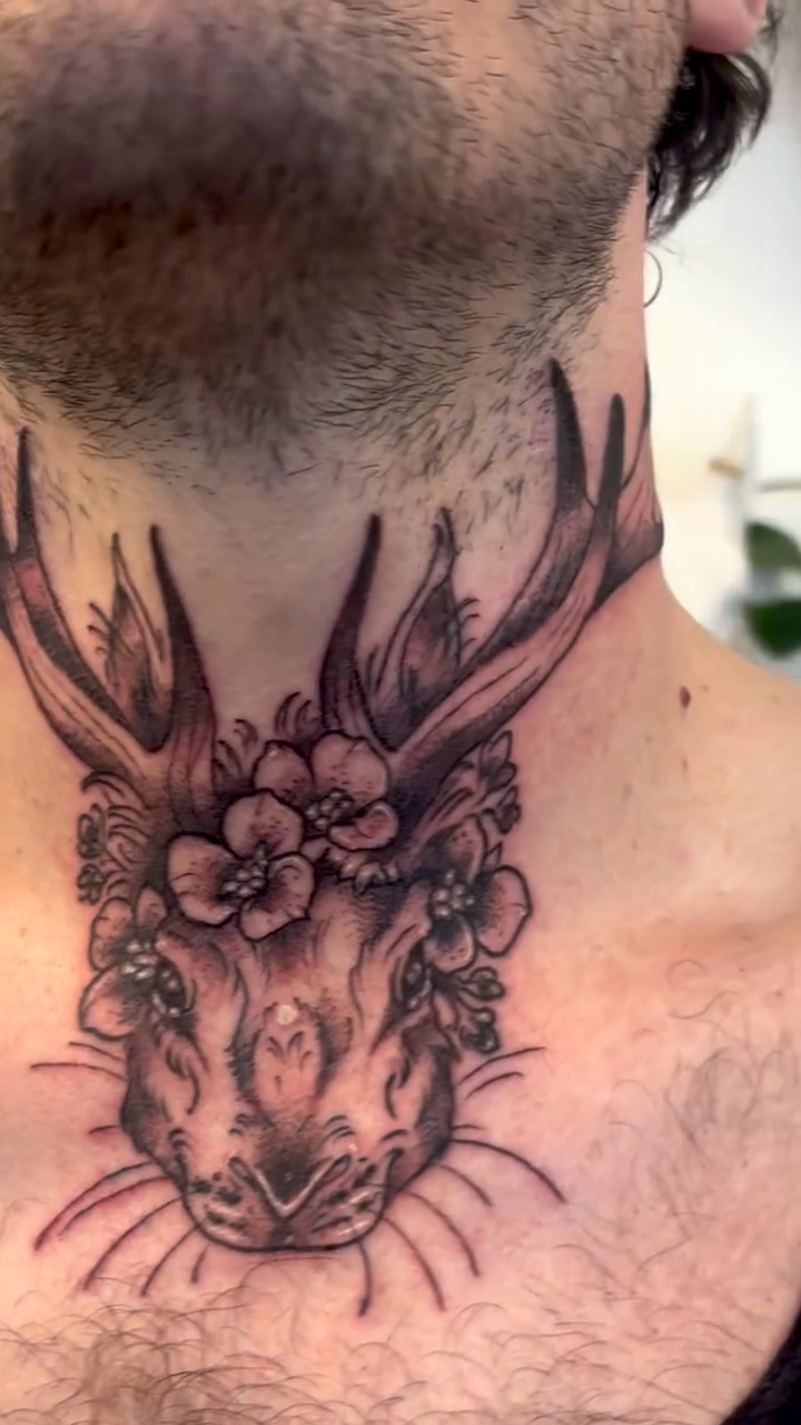 Deer head with flowers dark art tattoo on the neck by Cricket Elijah Cervidae