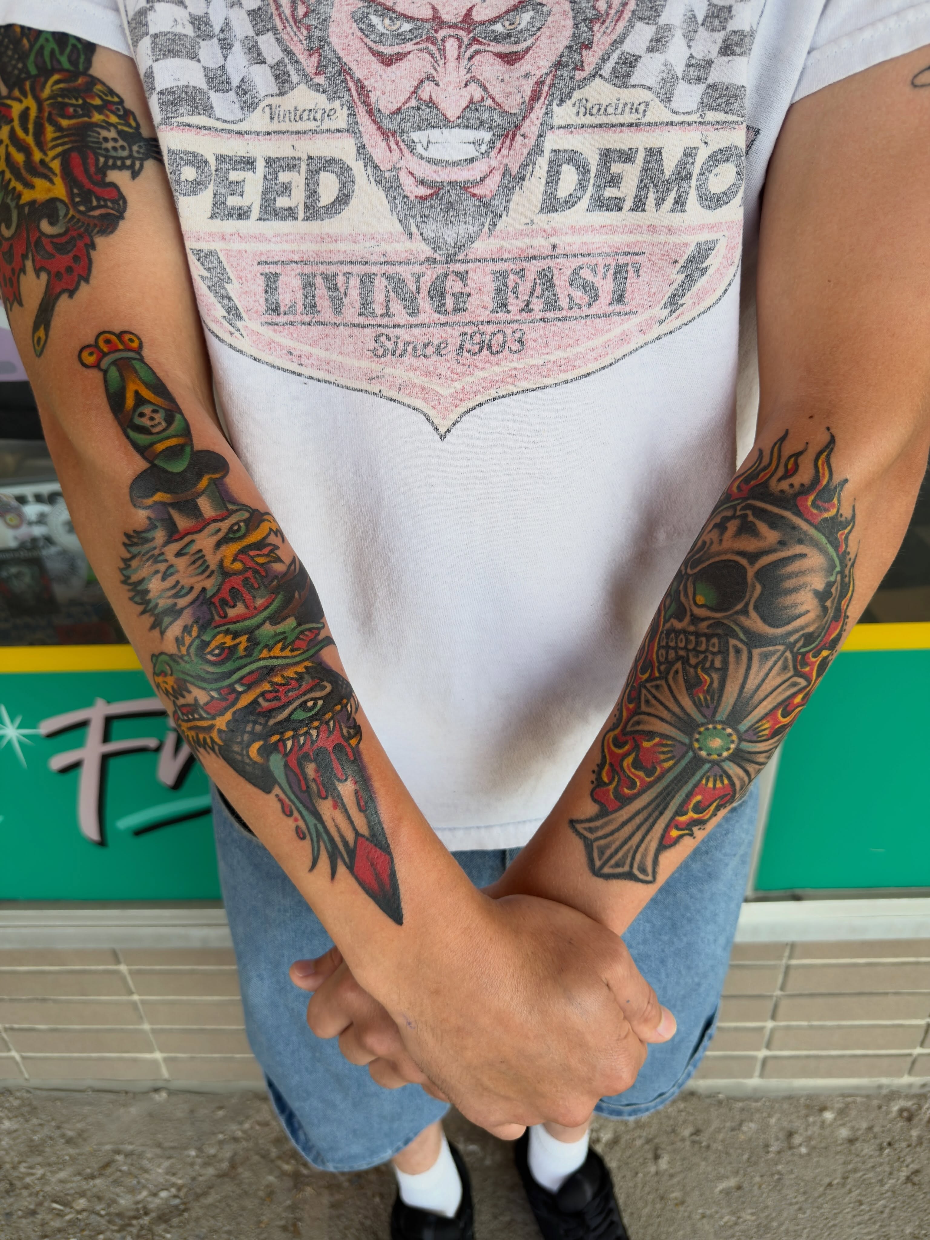 Skull and flames American traditional tattoo on the forearm by Joshua Speight