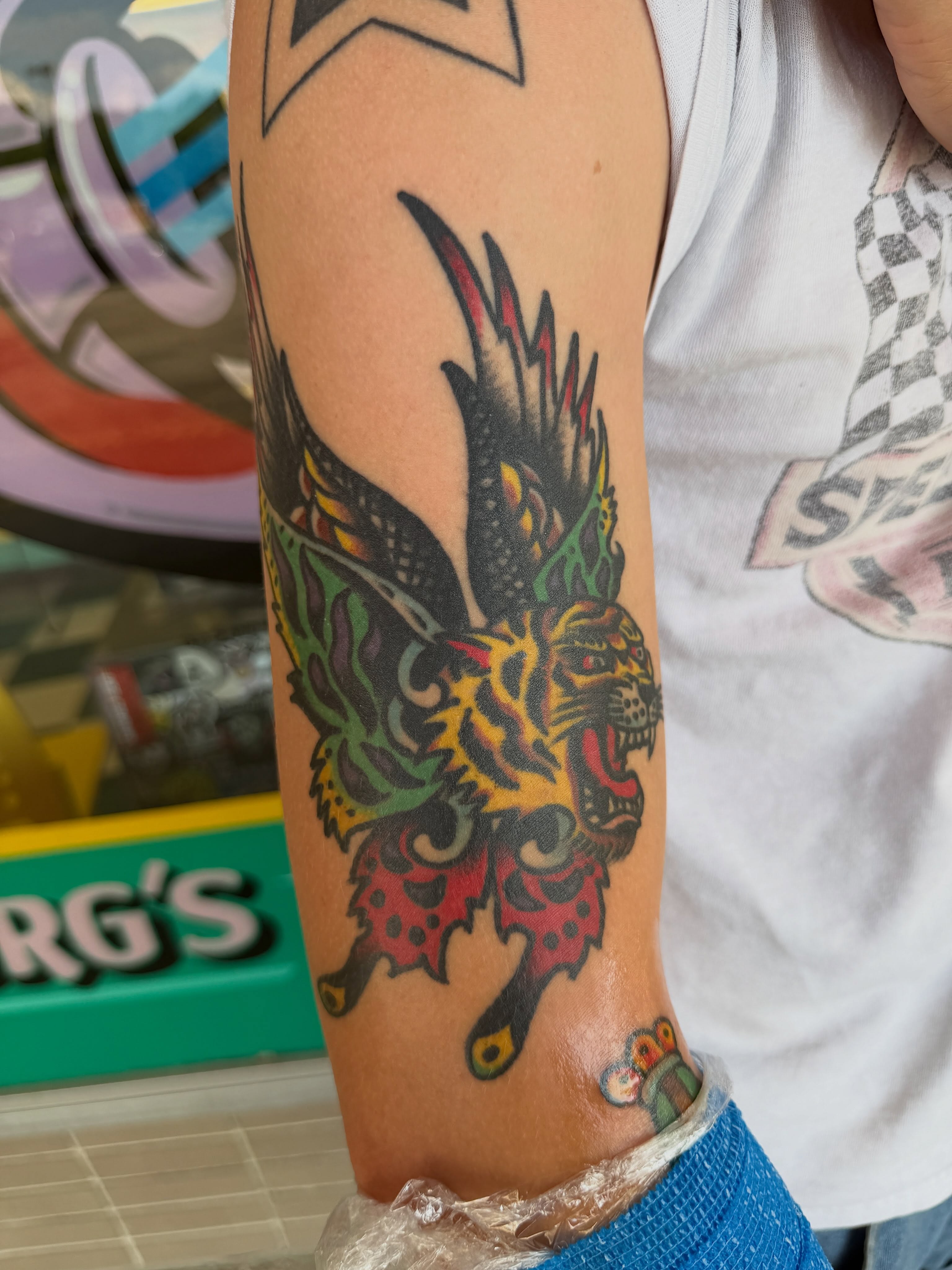 Tiger American traditional tattoo on the forearm by Joshua Speight