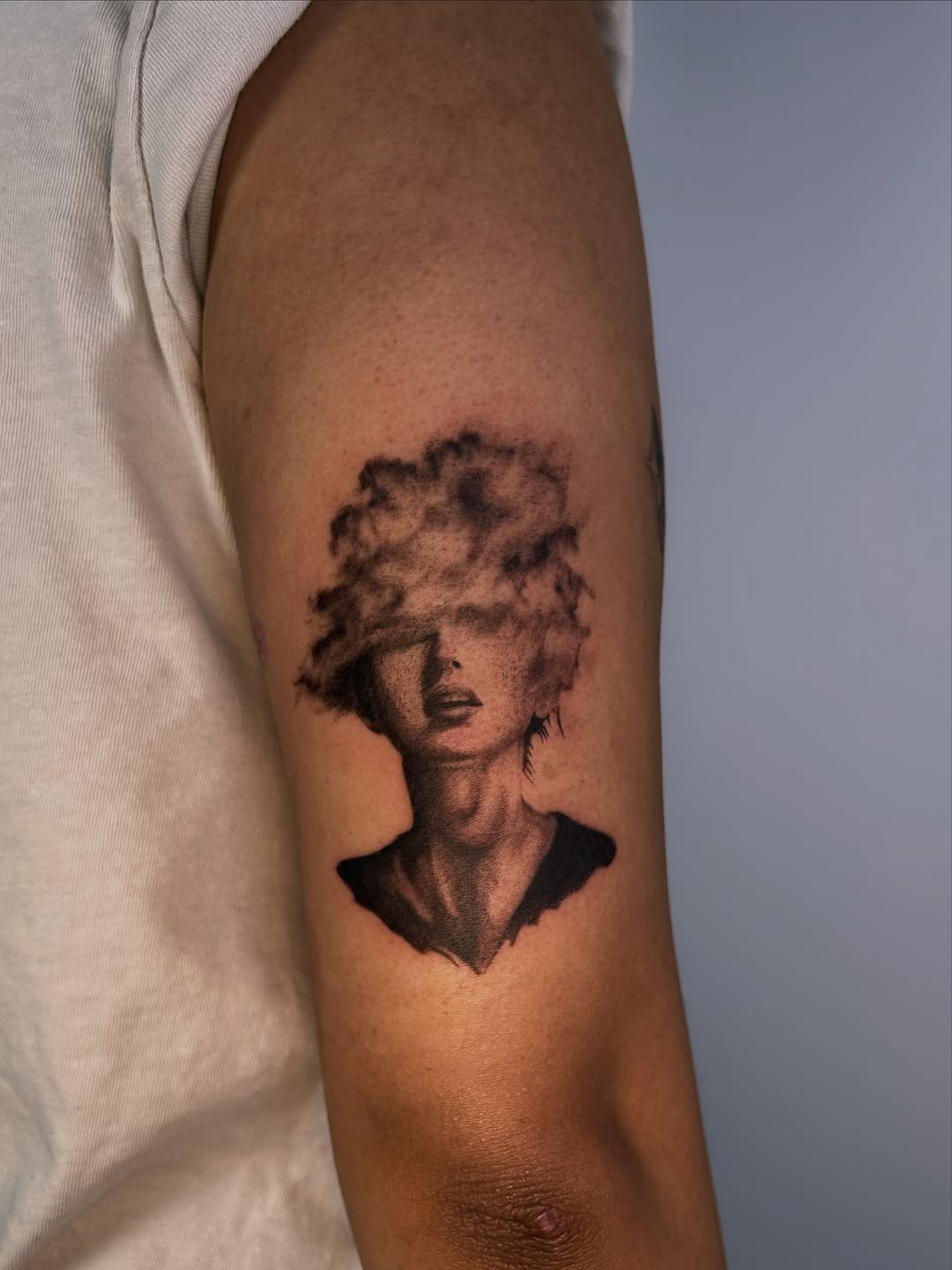 Woman with cloud hair surrealism tattoo on the forearm by J