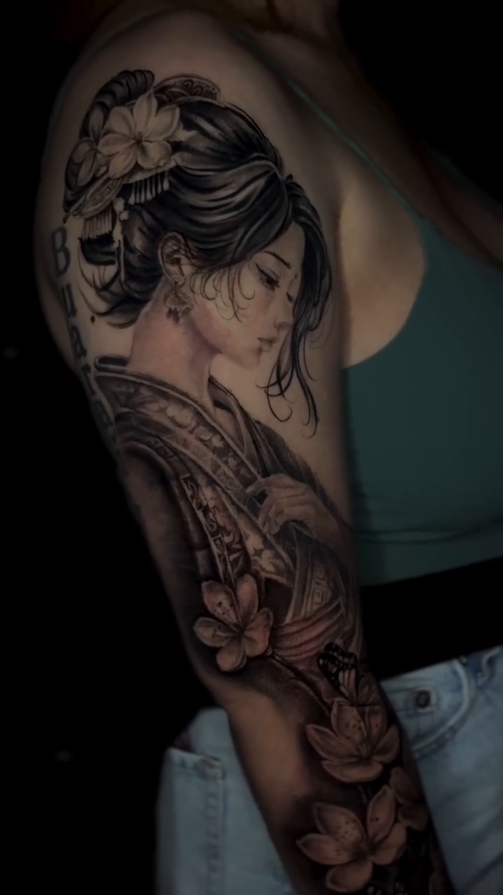 Geisha with flowers and butterflies realism tattoo on the forearm by @_frankyvee
