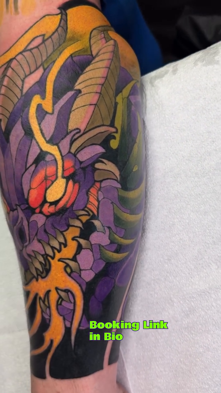 Dragon head and tentacles dark art tattoo on the forearm by Kiel Ferrari
