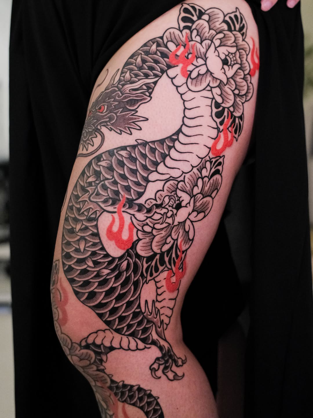 Dragon with peonies and flames Japanese tattoo on the thigh by seattle tattoo artist