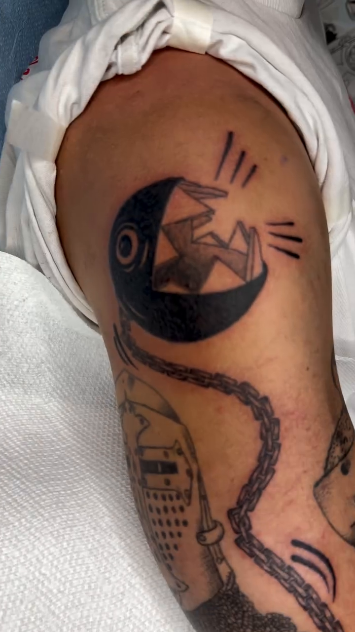 Moon, sun, and knight's helmet new school tattoo on the forearm by Giana Masso