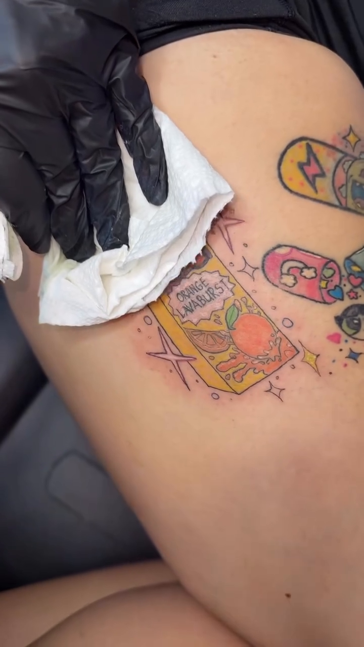 Juice box and skateboards ignorant tattoo on the thigh by Felicia Lee, Des Moines, Iowa