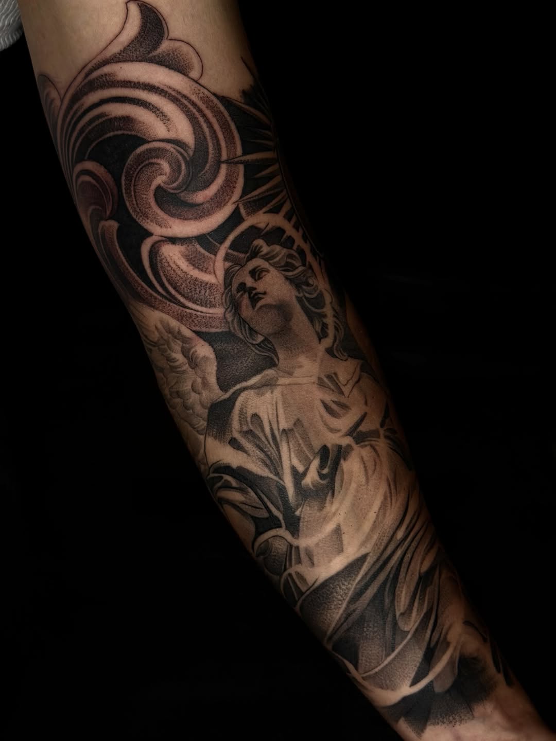 Angel with ornate background realism tattoo on the forearm by San Diego Tattoo Artist