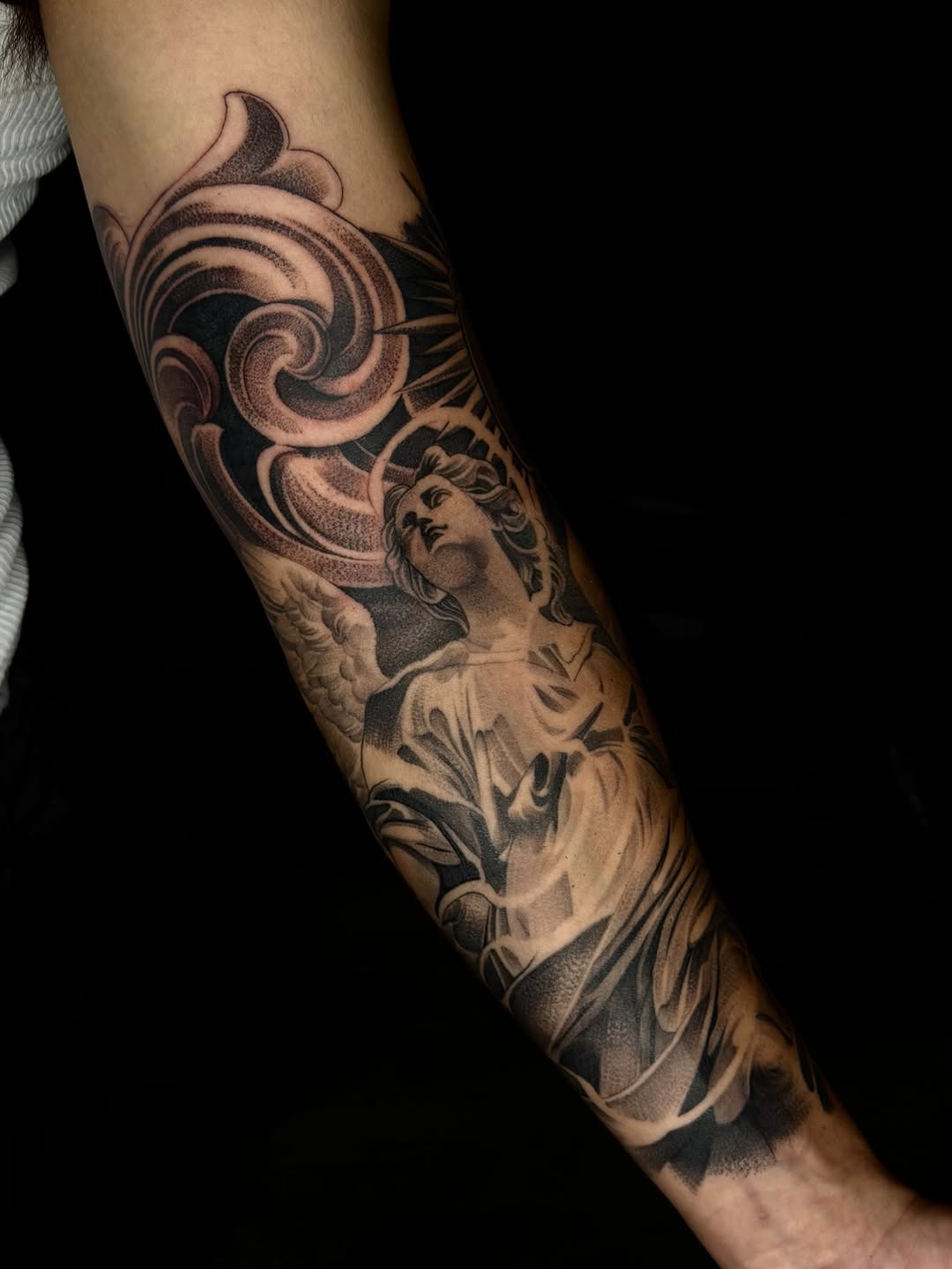 Angel with ornate background realism tattoo on the forearm by San Diego Tattoo Artist