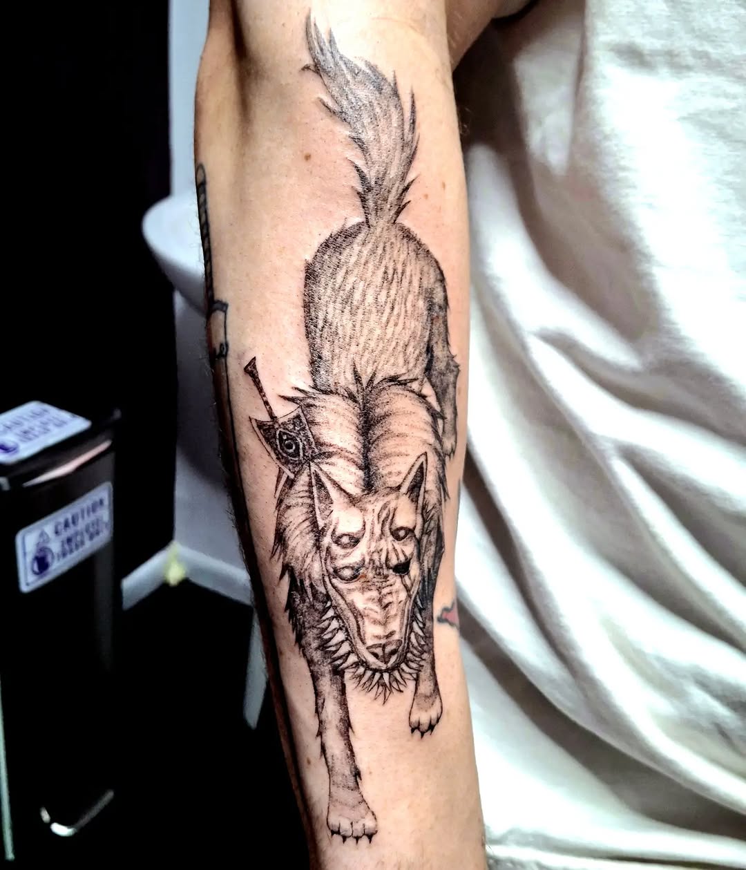 Wolf with sword realism tattoo on the forearm by hallowed girl tattoo