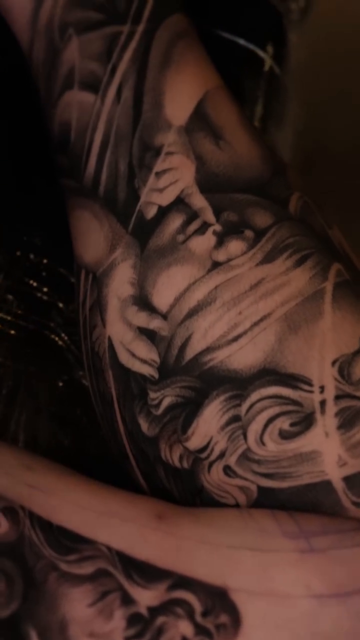 Realism tattoo on the upper arm by Ana Fajardo