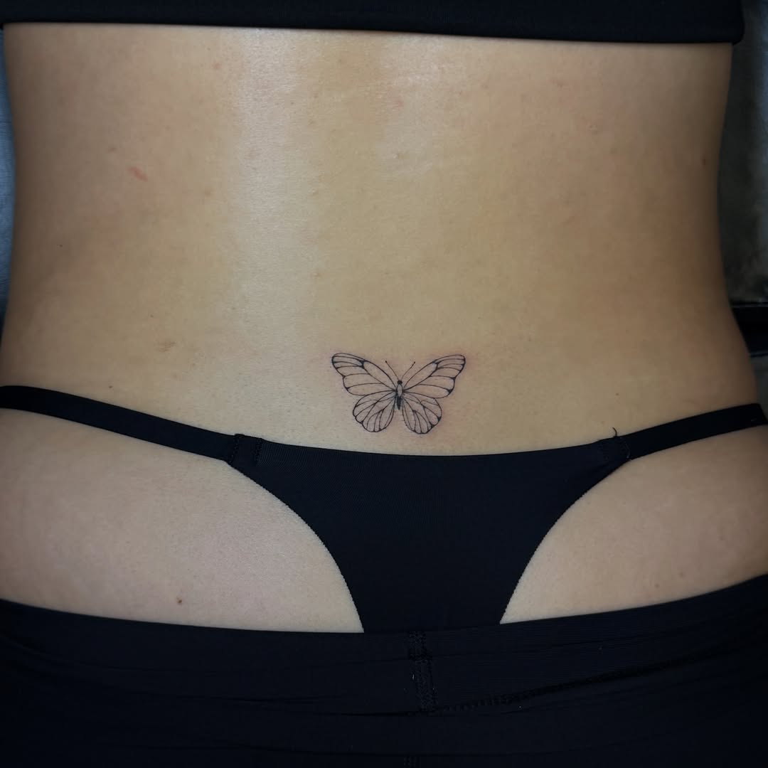 Butterfly fine line tattoo on the torso by Pretty Ugly Tattoos